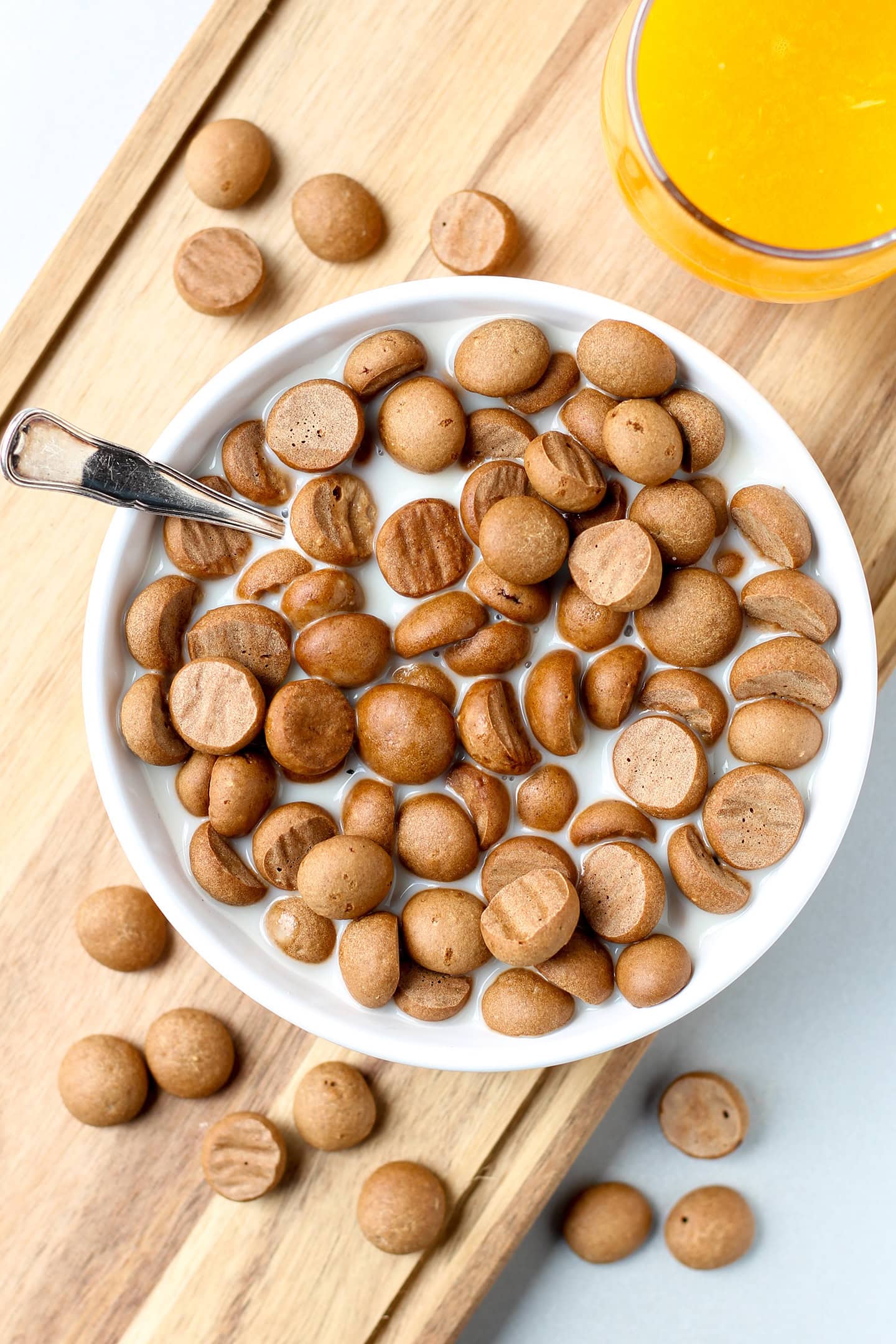 A bowl filled with cinnamon cereal on a wooden board.