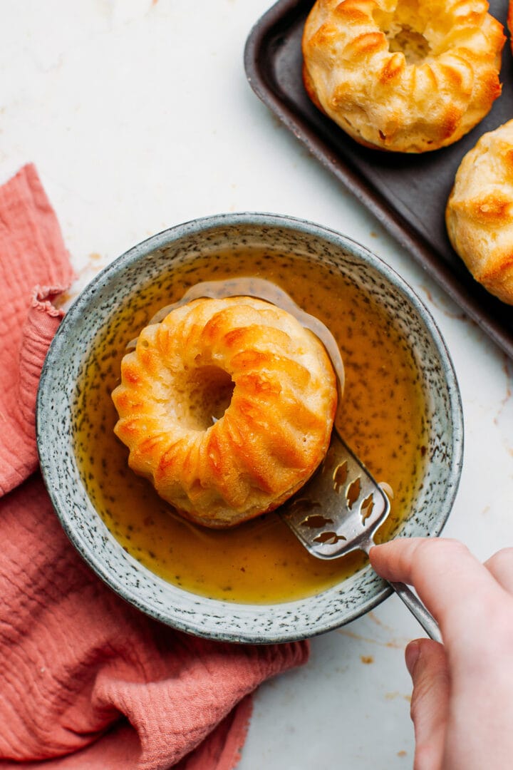 Dipping baba in rum syrup.