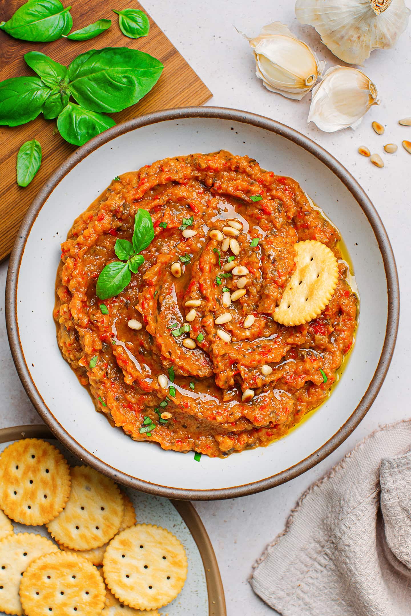 Eggplant and tomato dip topped with toasted pine nuts and chopped basil.