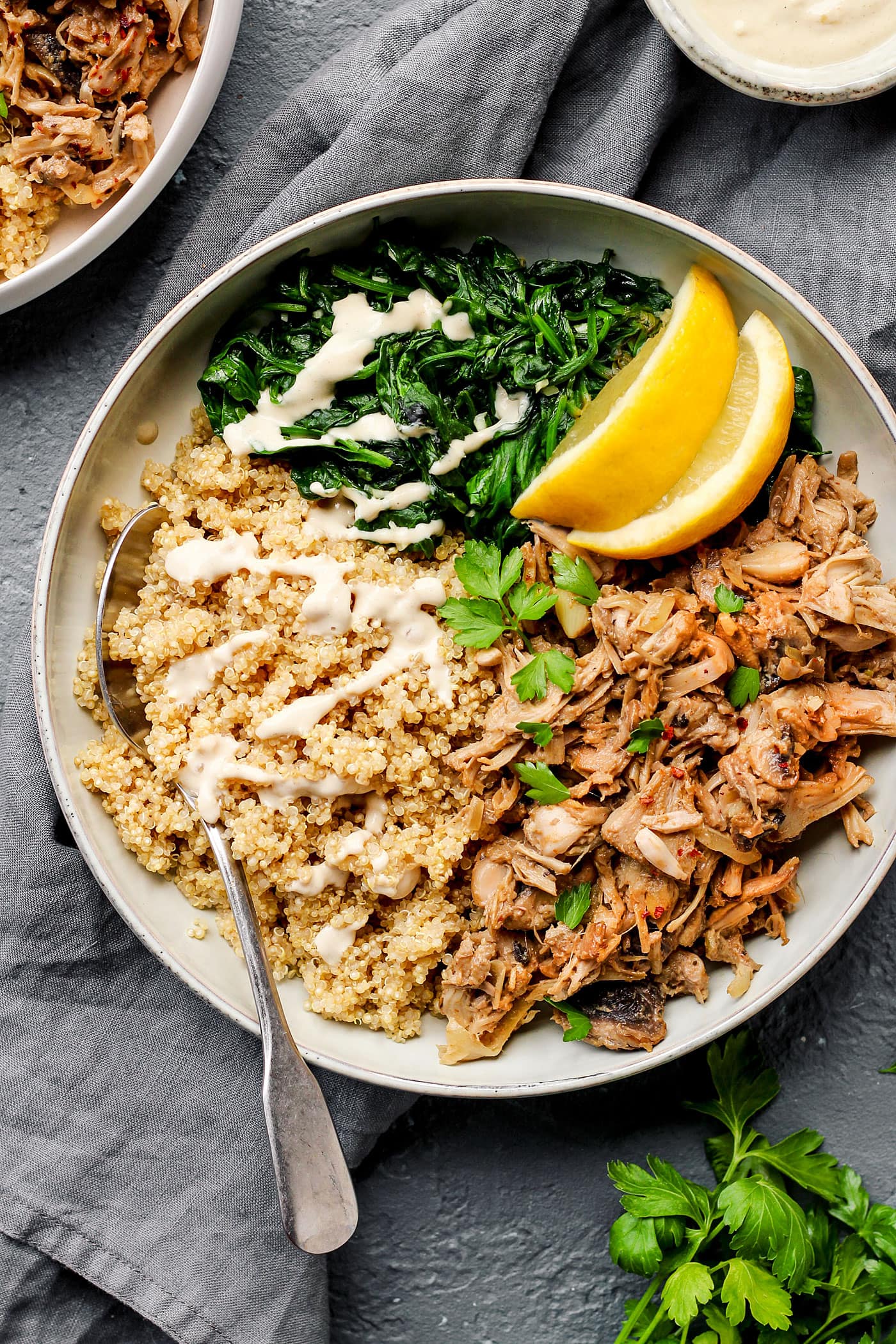 Jackfruit "chicken with quinoa, spinach, and cilantro in a bowl.