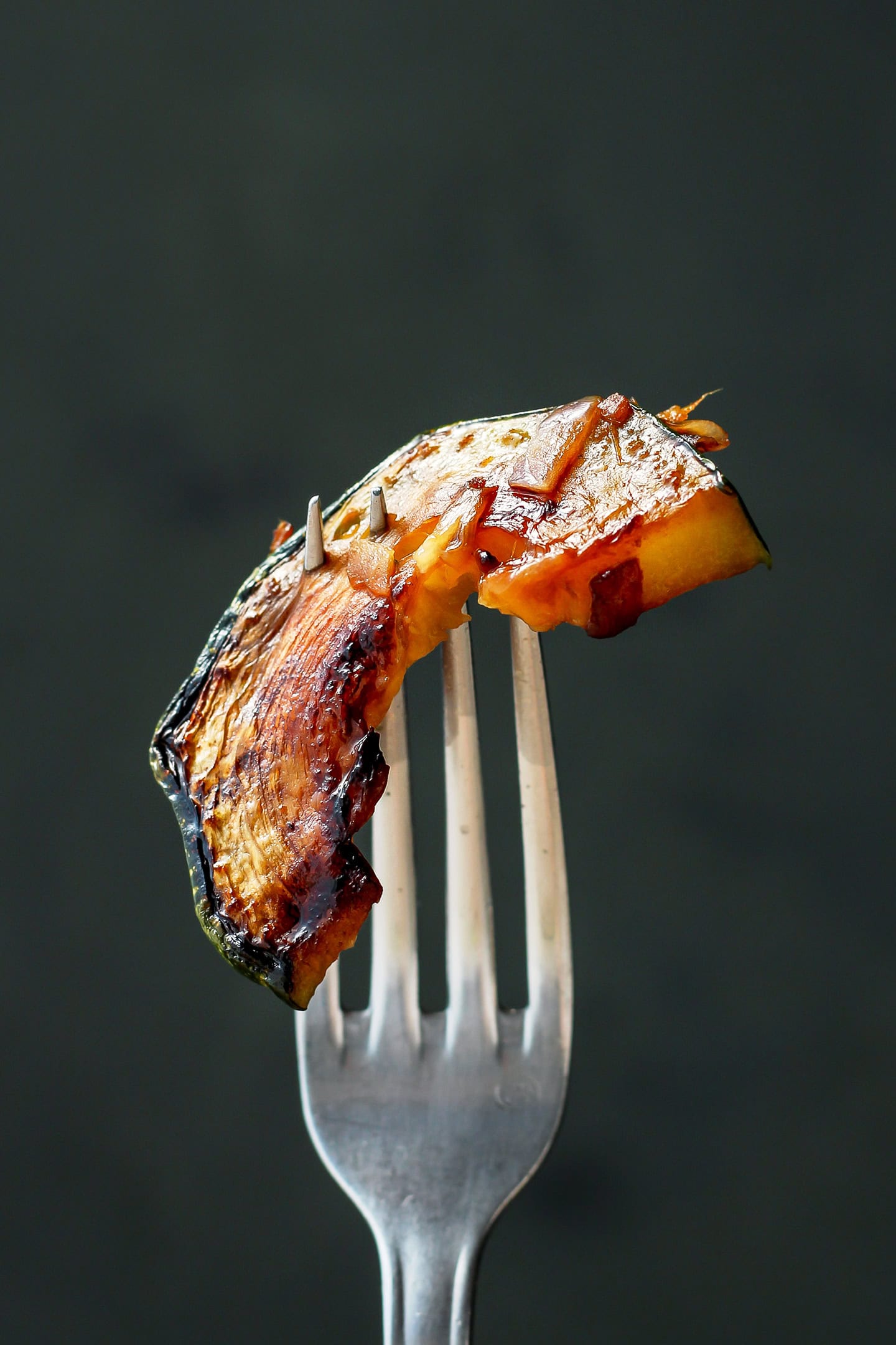 Slice of caramelized zucchini on a fork.