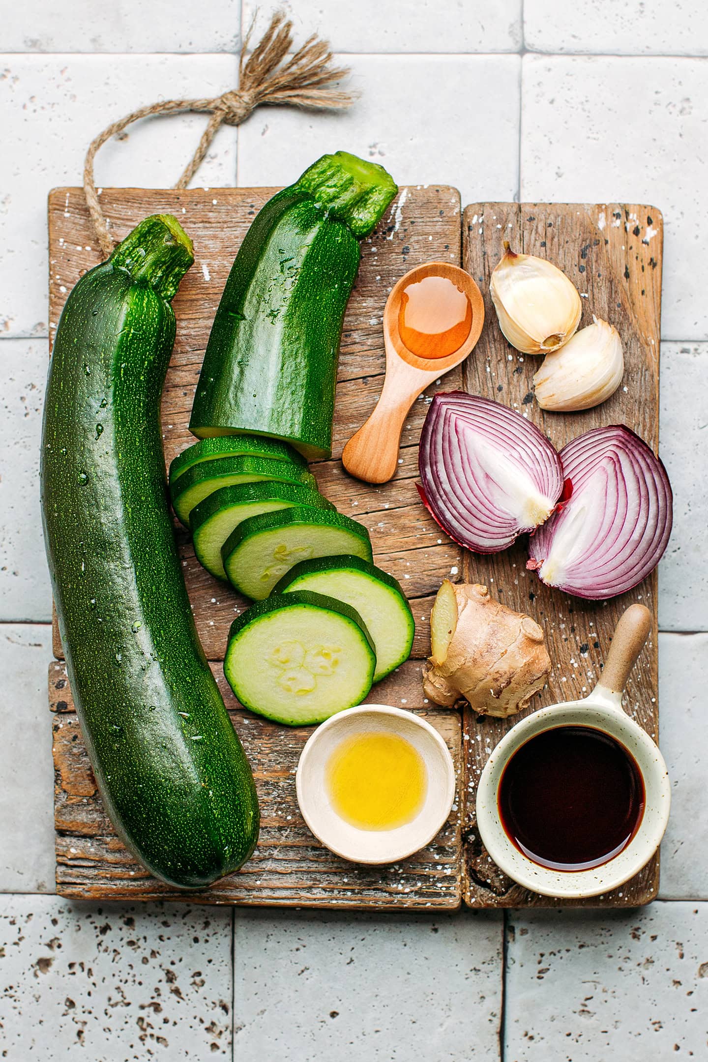 Ingredients like zucchini, red onion, garlic, ginger, and soy sauce.
