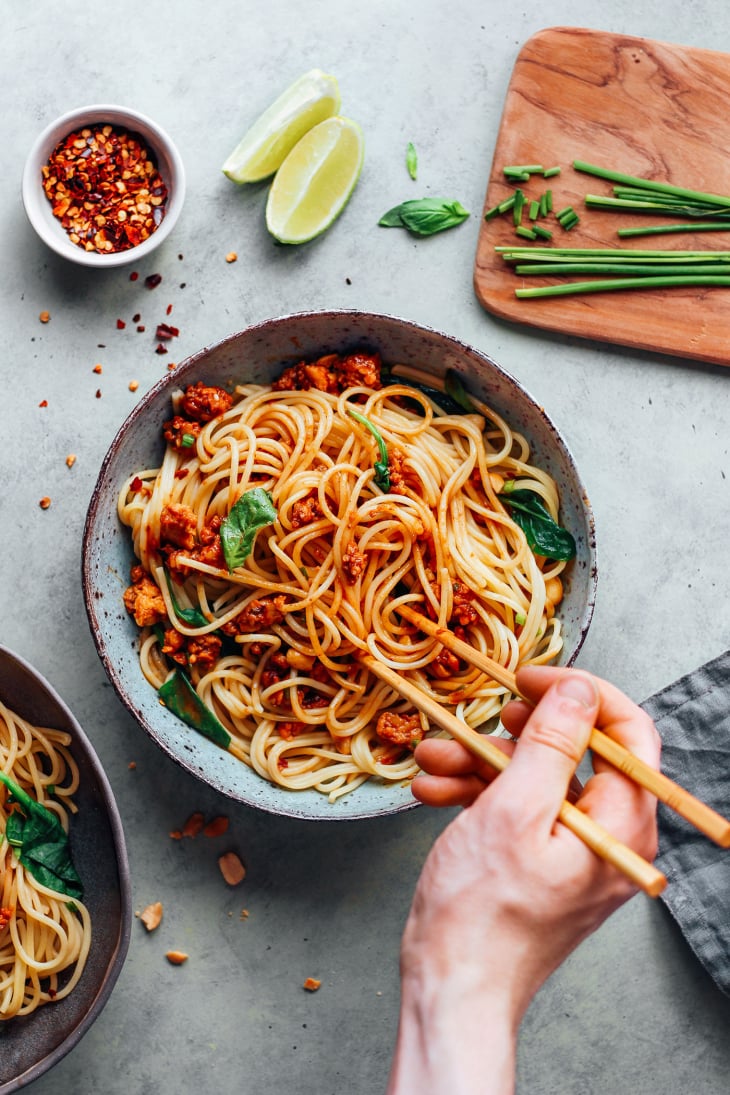 Stirring noodles with five-spice tempeh.
