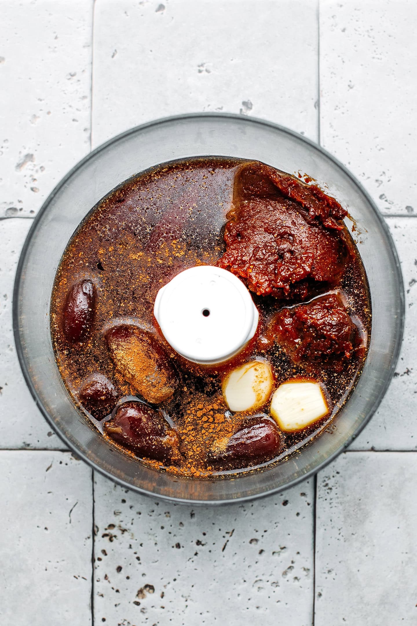 Maple syrup, dates, garlic, and soybean paste in a food processor.