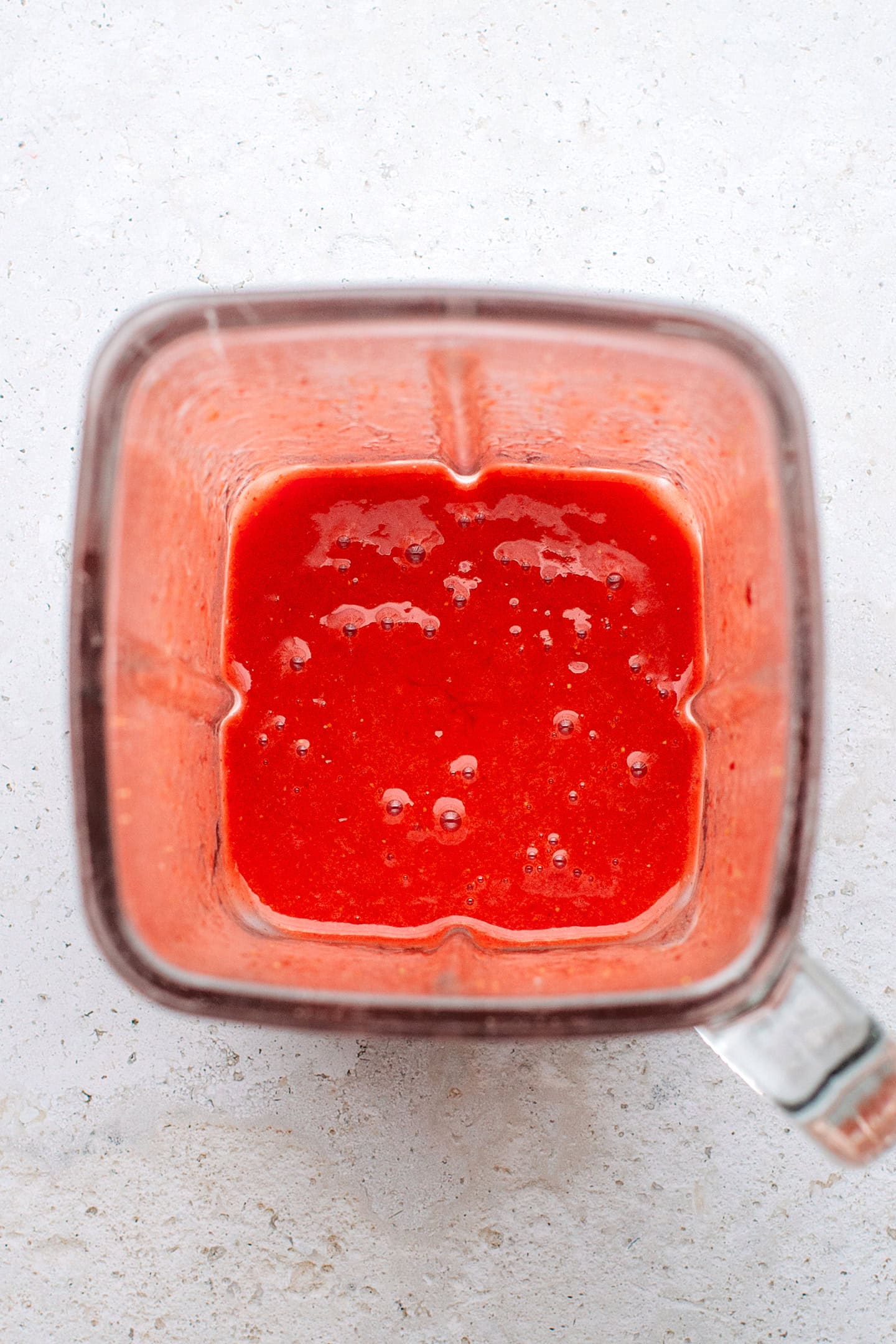 Blended strawberries in a blender.
