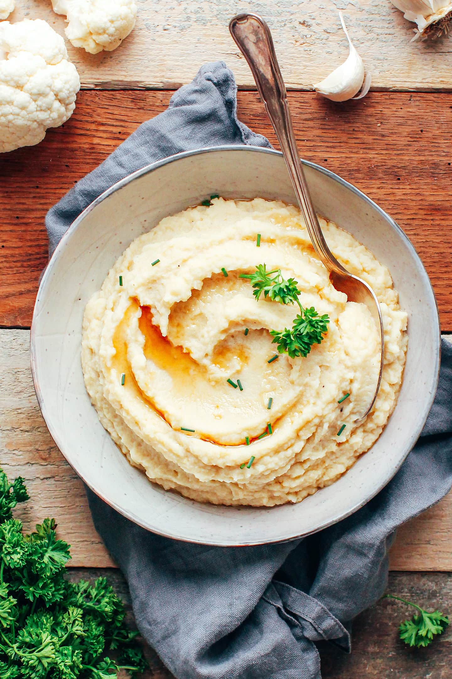 Celery root & cauliflower purée garnished with parsley in a bowl.