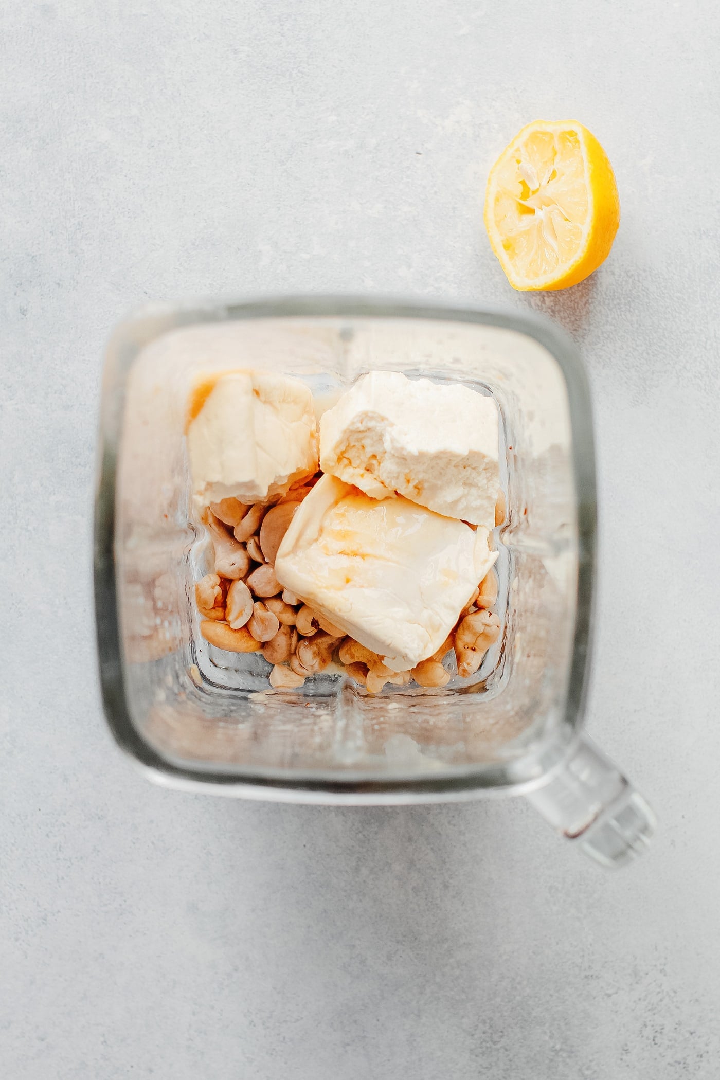 Tofu, cashews, and maple syrup in a blender.
