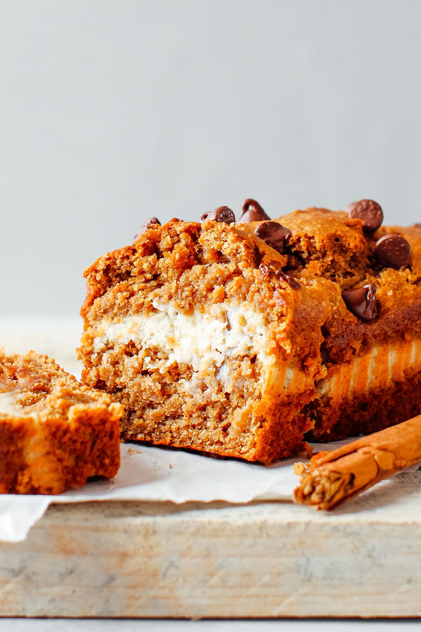 Slice of banana bread with cream cheese and chocolate chips.