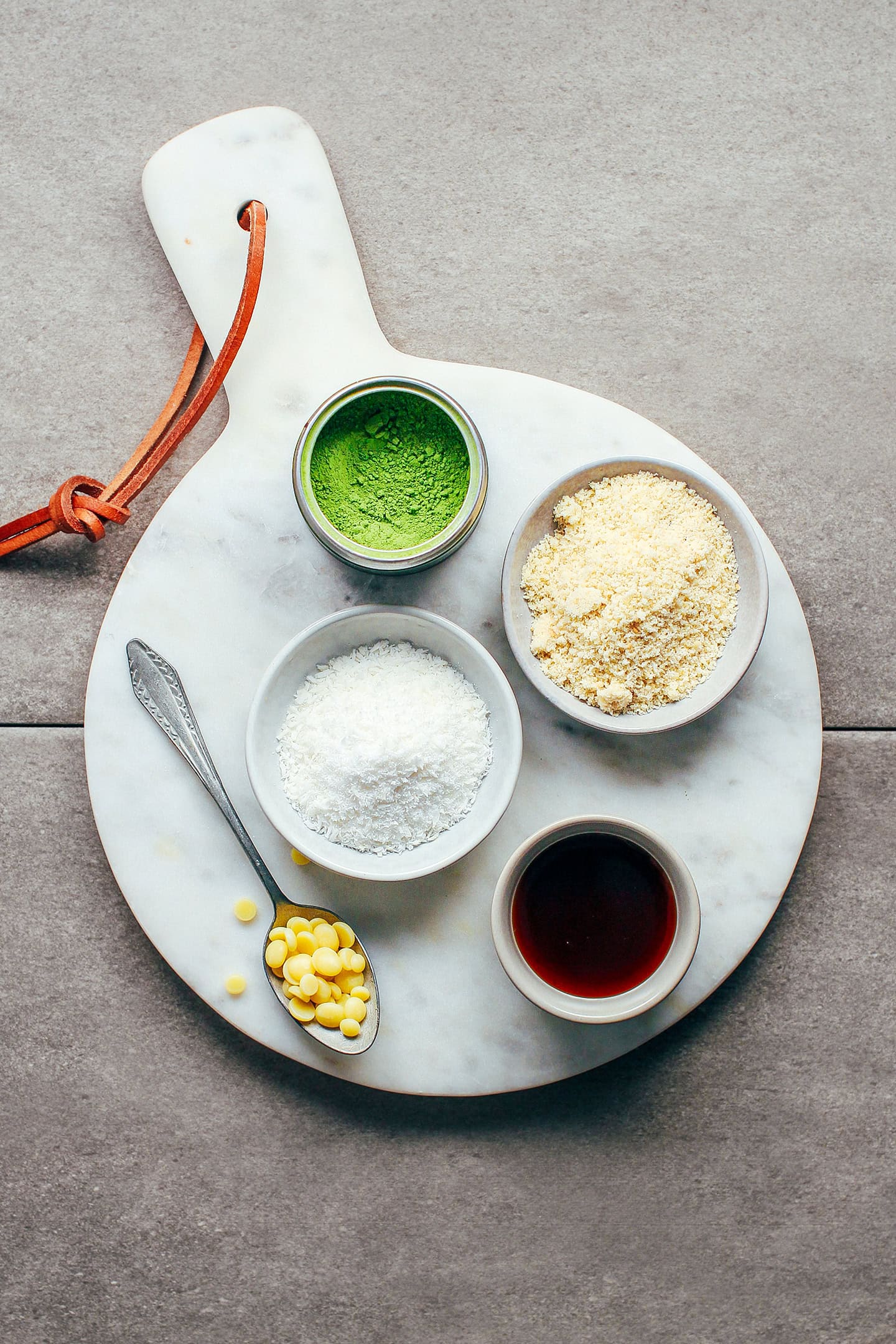 Ingredients like almond flour, shredded coconut, matcha powder, and coconut syrup.