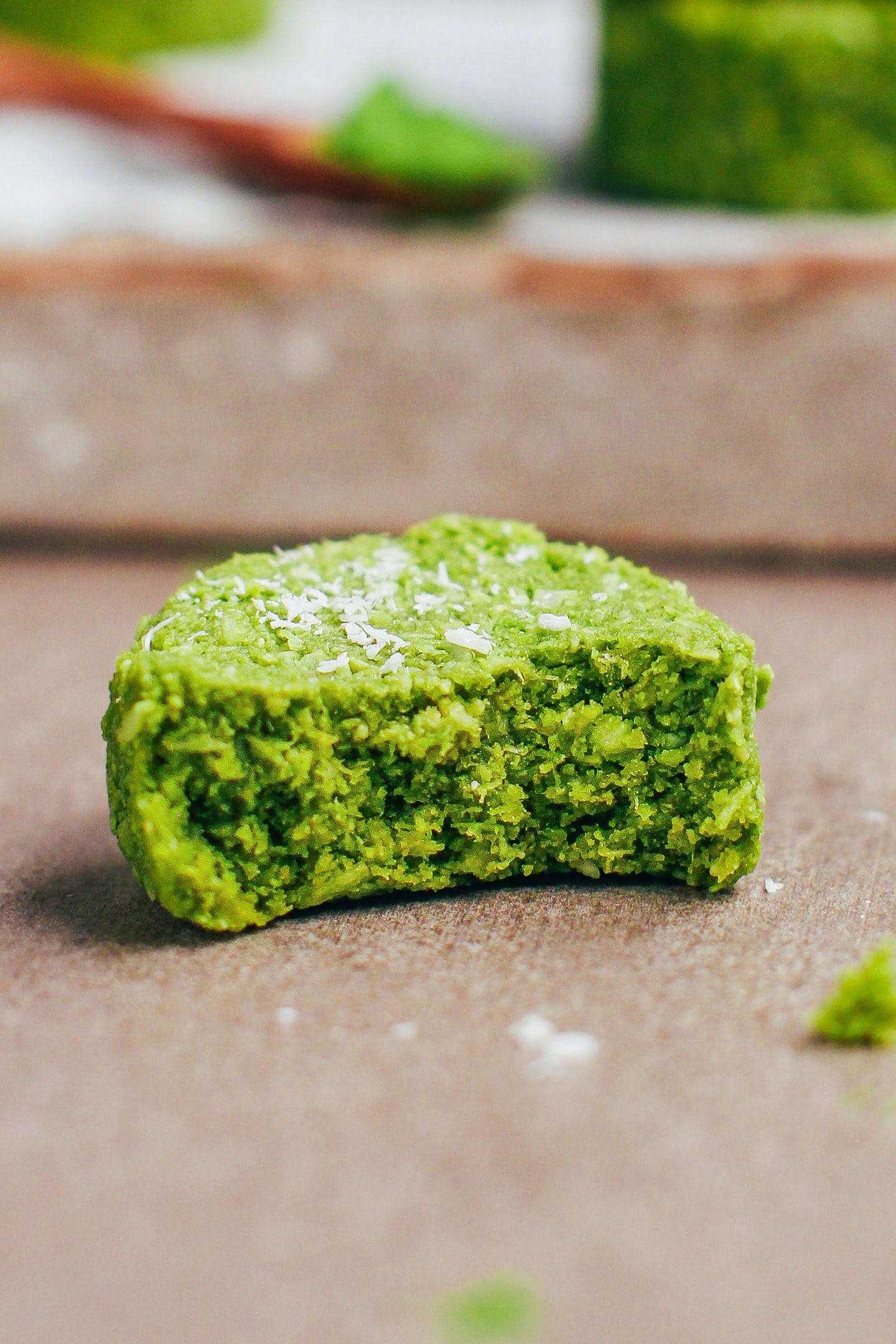 Close-up of a bite of coconut matcha cookie.