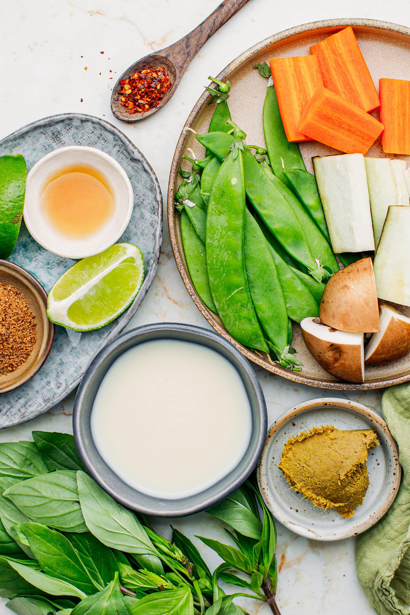 Ingredients like ccoconut milk, snow peas, and mushrooms.