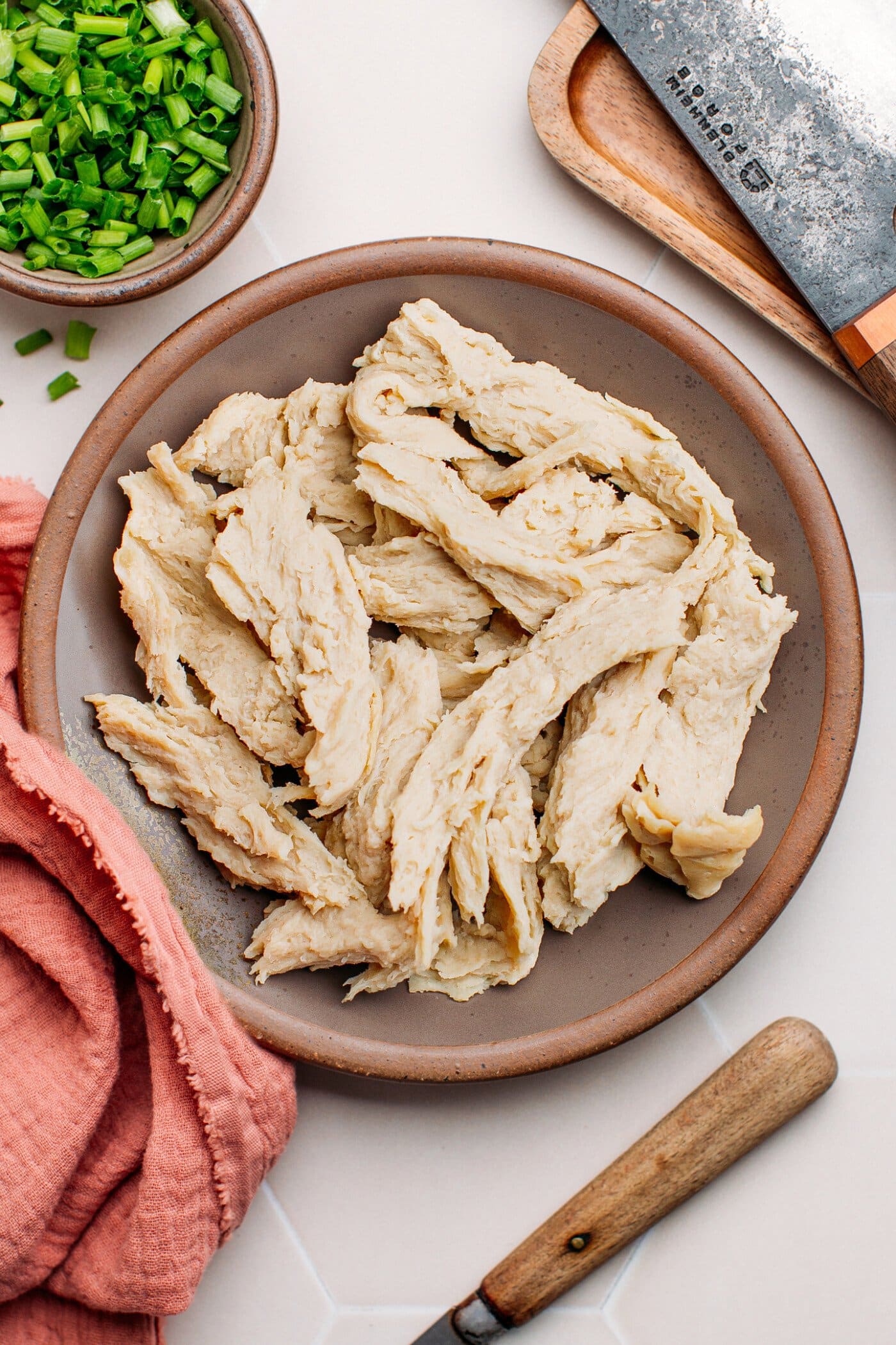 Vegan shredded chicken on a ceramic plate.