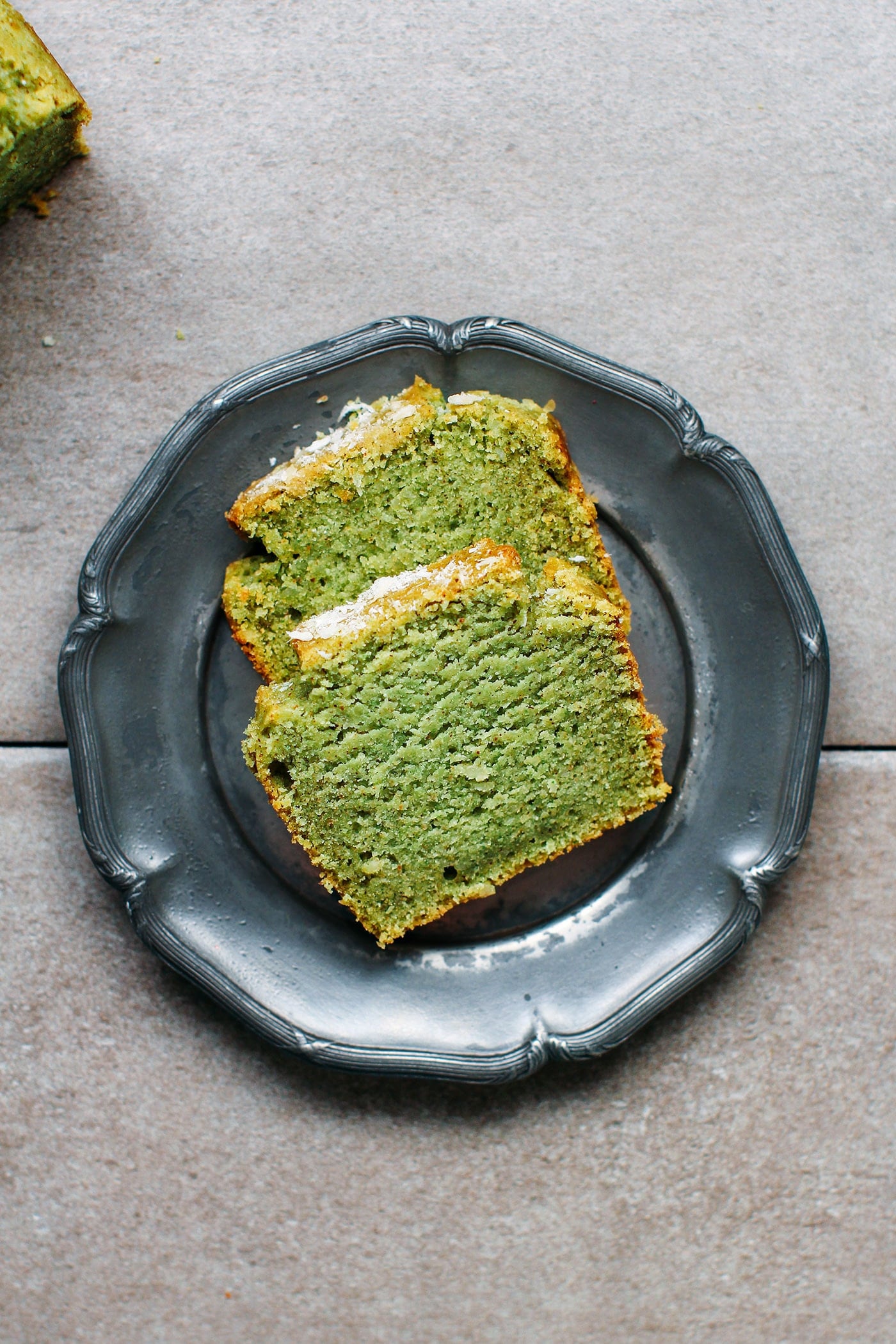 Two slices of pandan bread on a small plate.