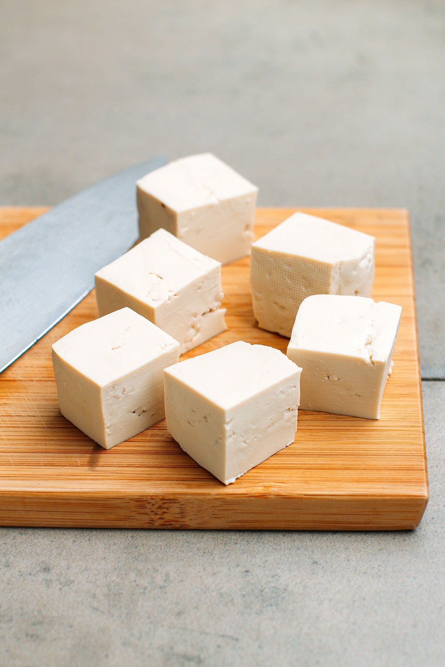 Diced tofu on a cutting board.