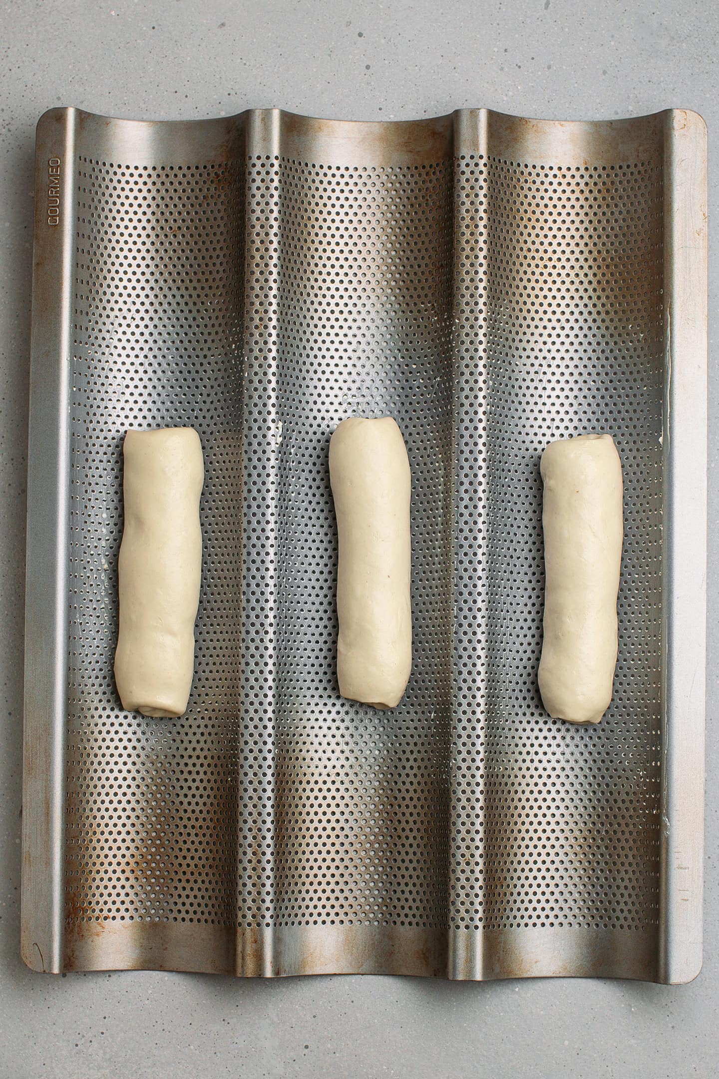 Loaves of baguette in a baguette pan.