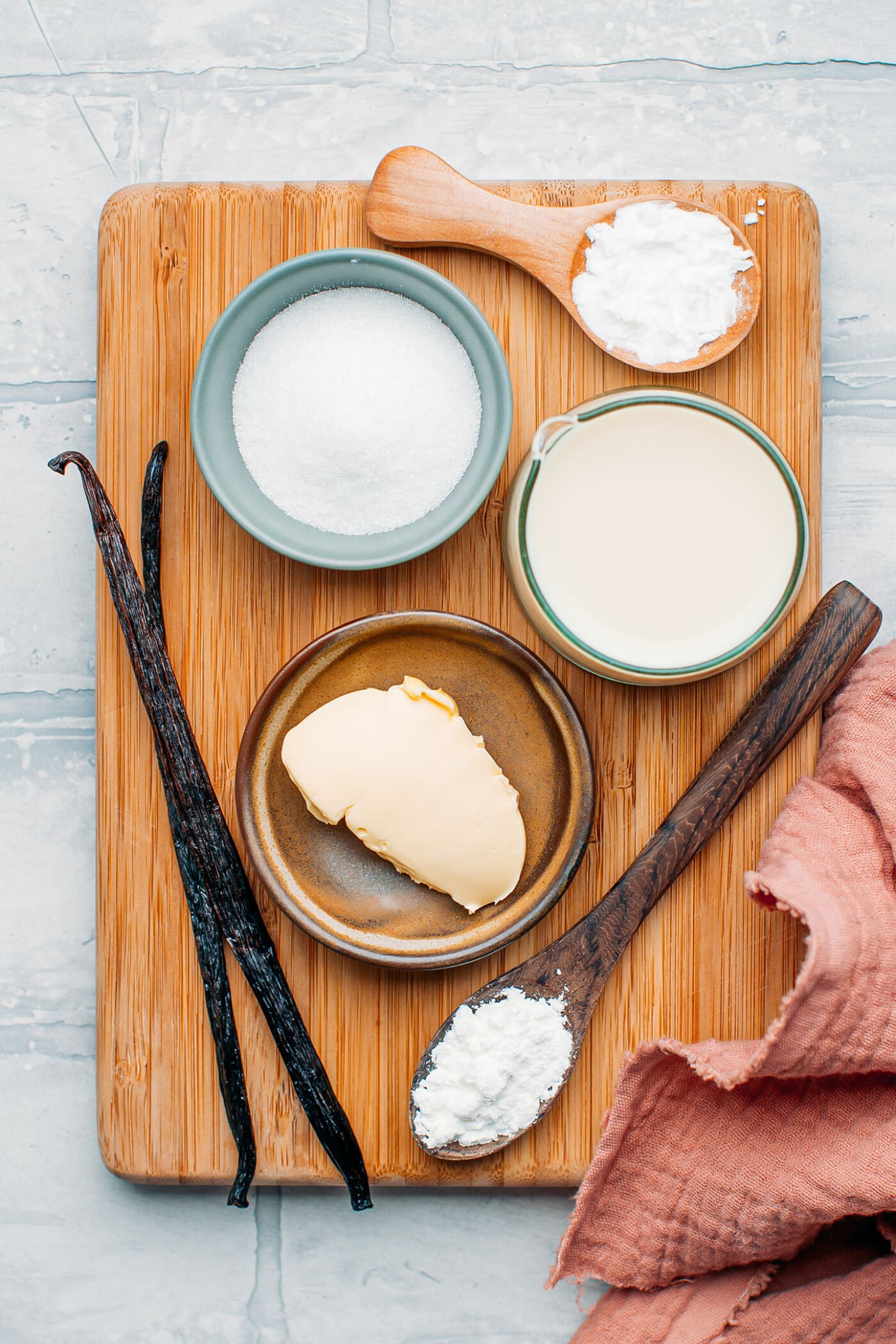 Ingredients like butter, vanilla beans, sugar, and cornstarch.
