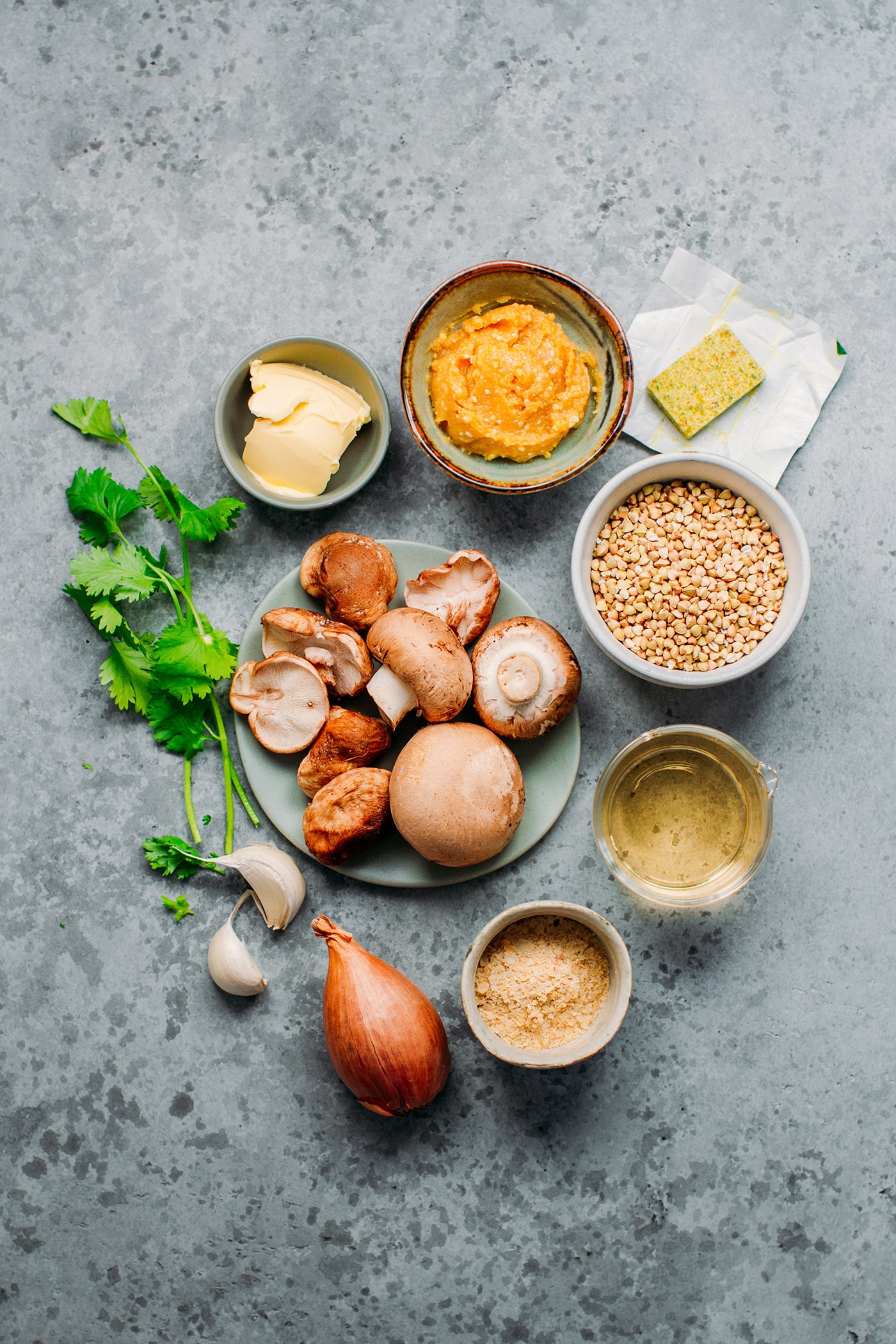 Ingredients like mushrooms, buckwheat, miso, shallots, garlic, and butter.