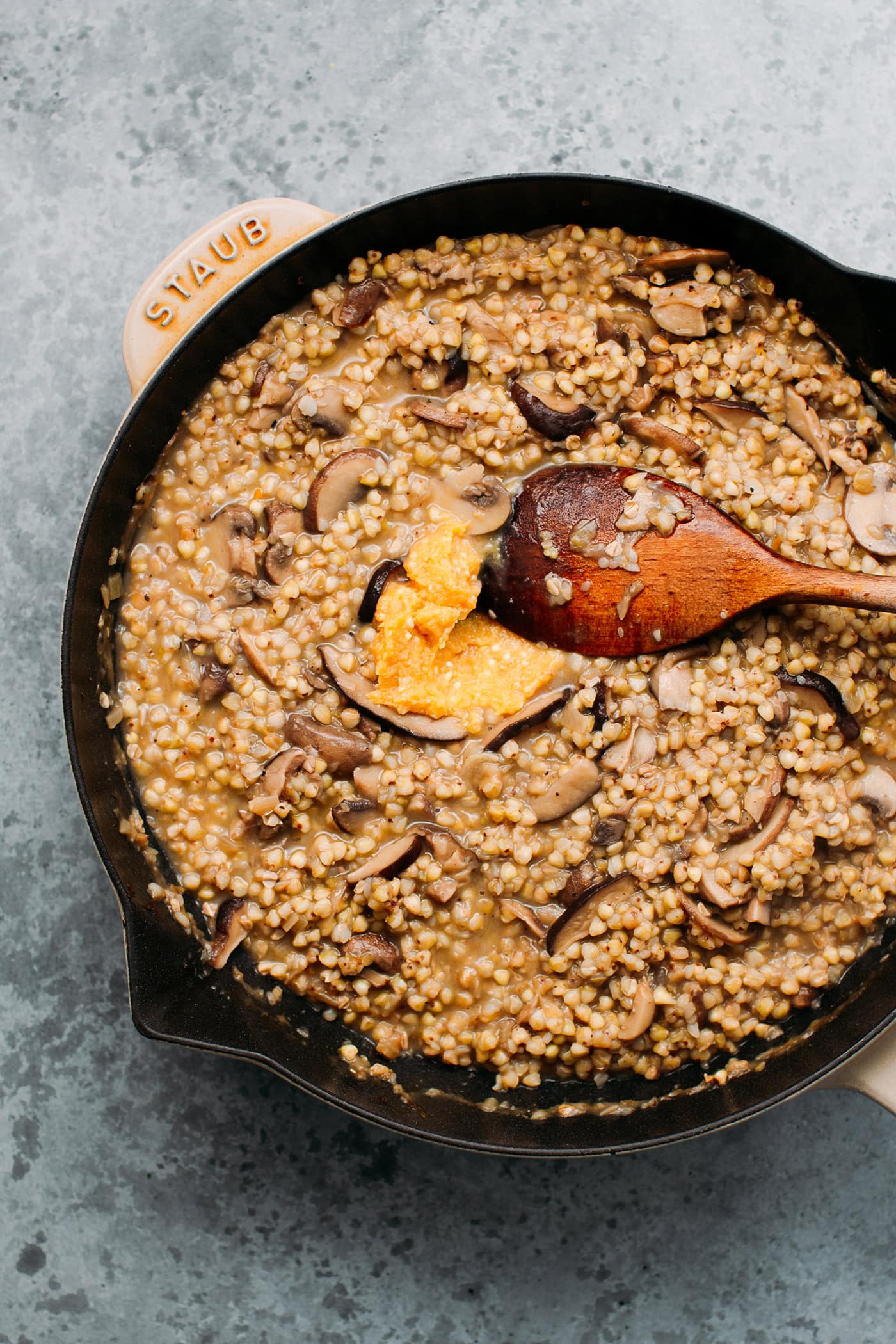 Buckwheat risotto with miso and mushrooms in a skillet.