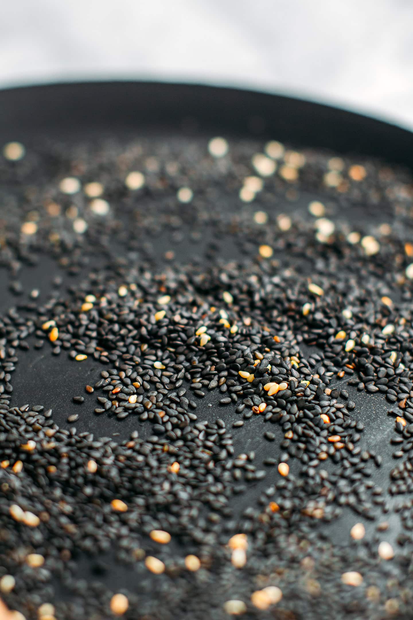 Close-up of toasted sesame seeds in a skillet.