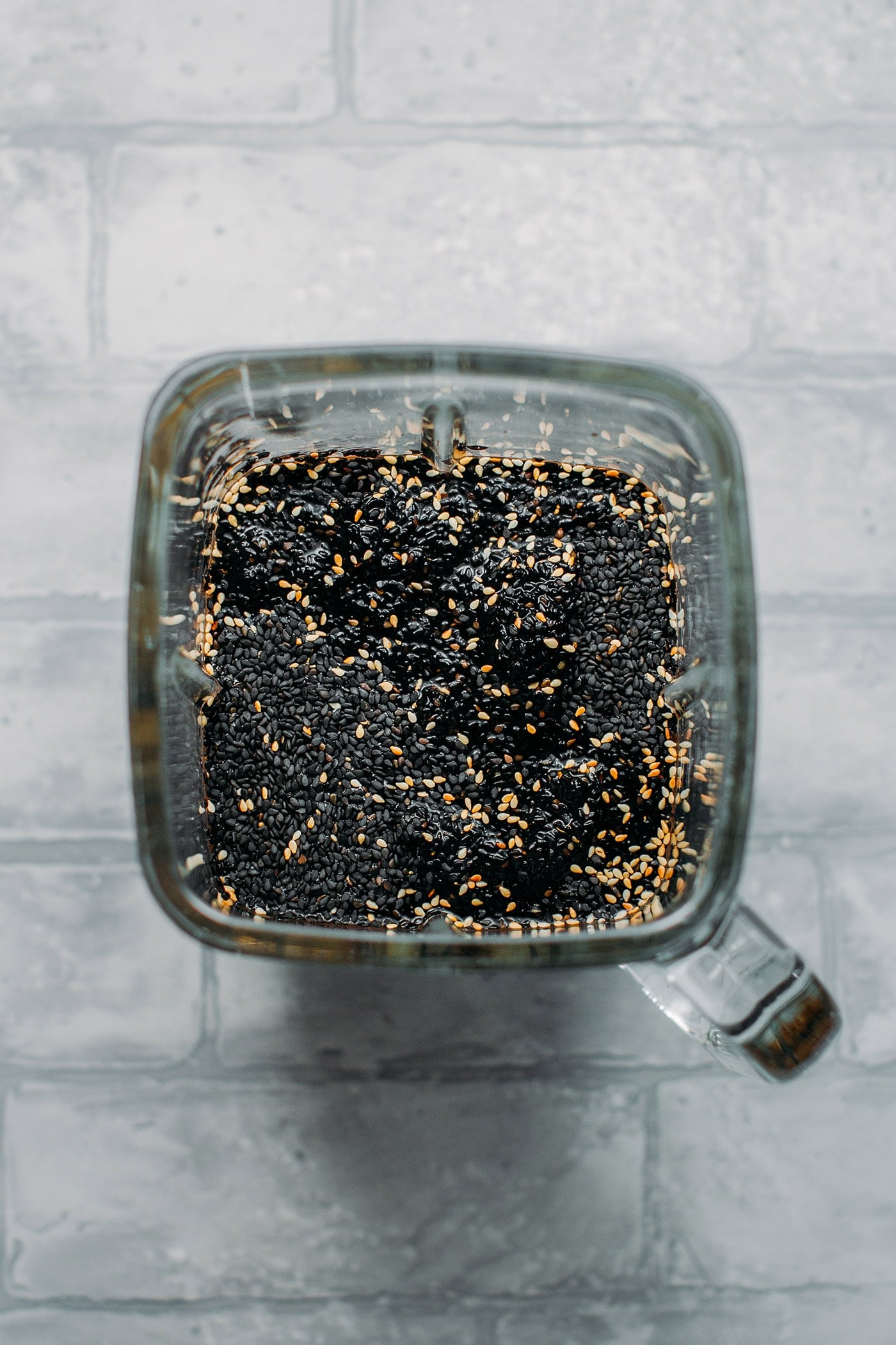 Roasted black sesame seeds and water in a blender.