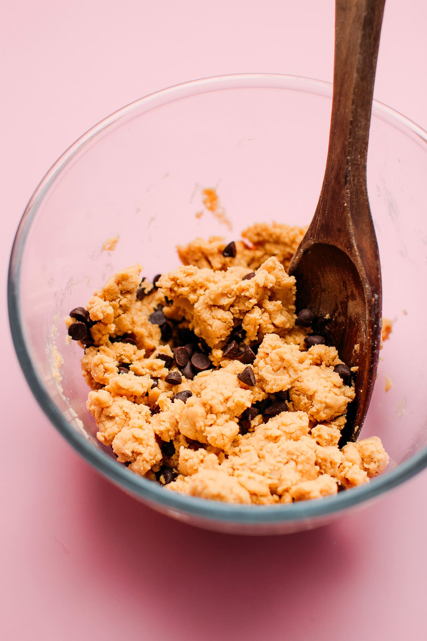Cookie dough with chocolate chips in a mixing bowl.