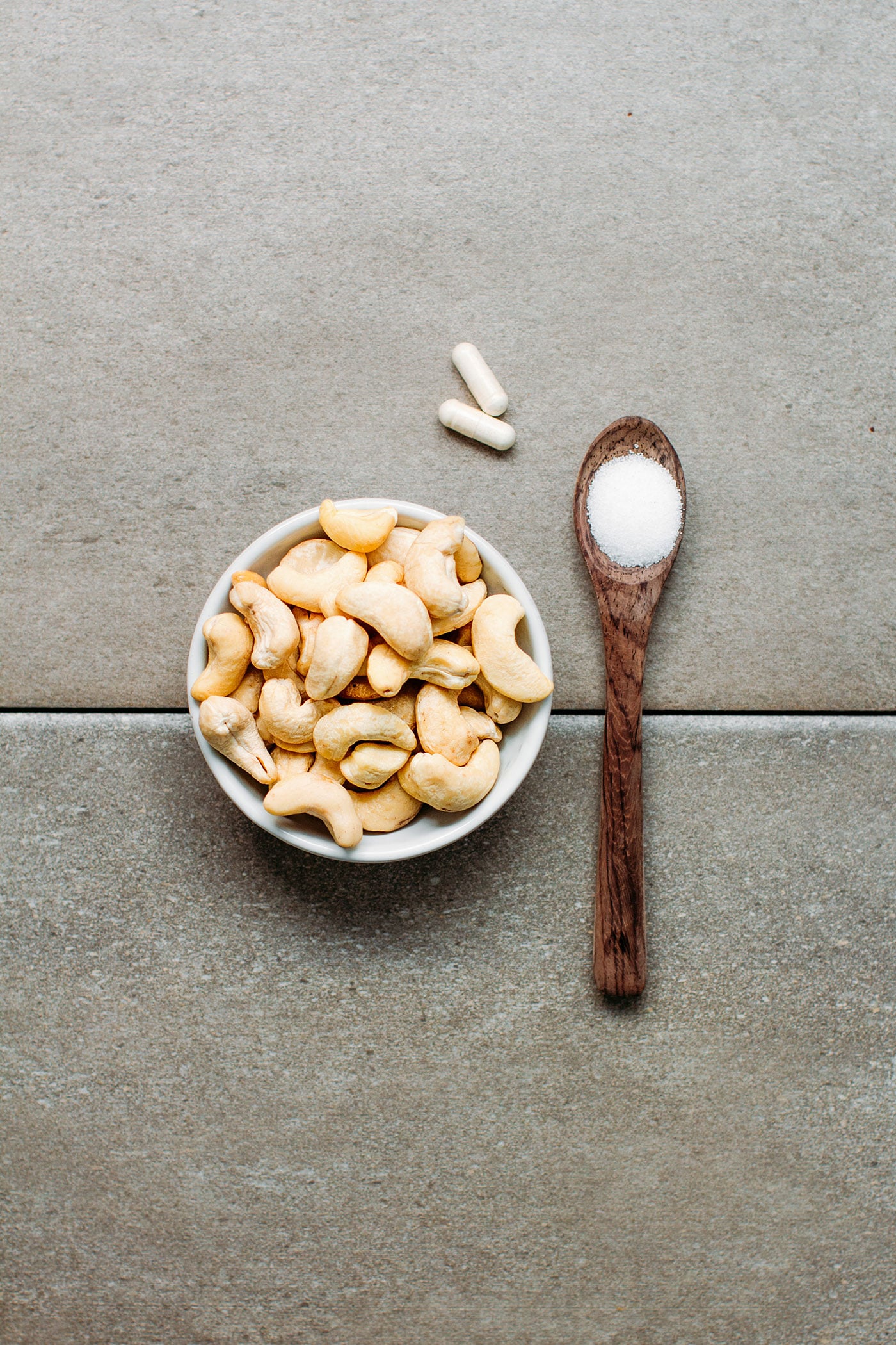 Ingredients to make vegan cream cheese, cashews, probiotics, and salt.