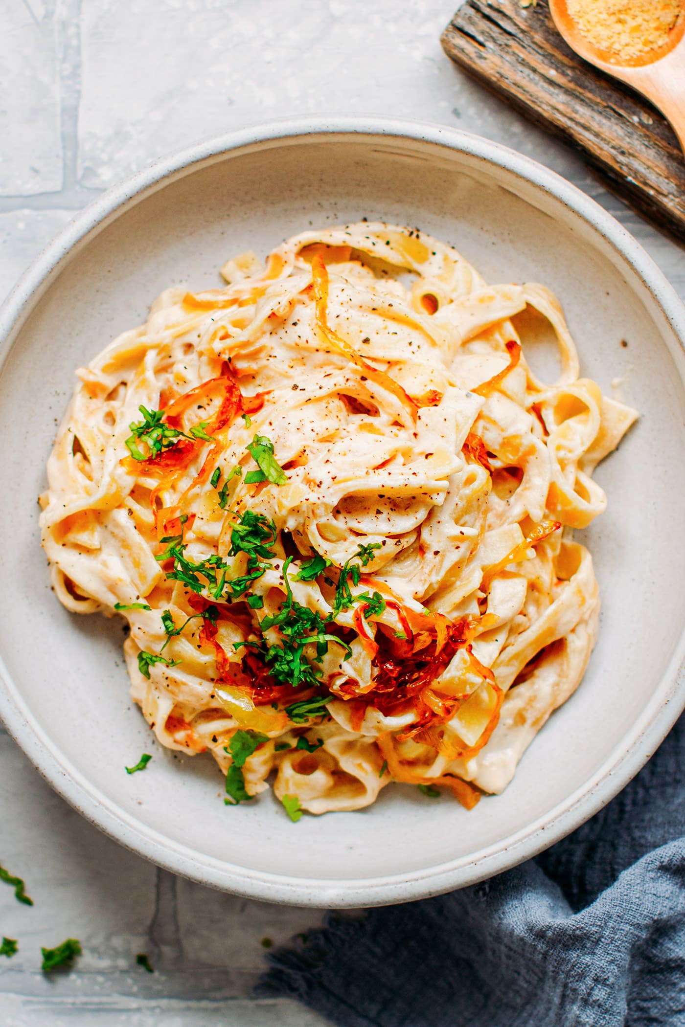 Creamy pasta with caramelized onions on a plate.