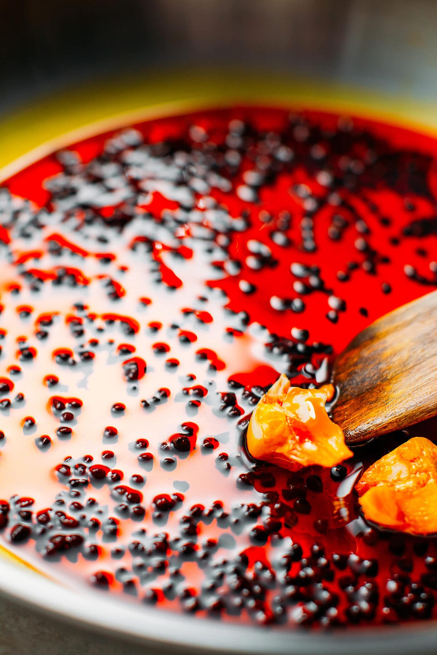 Frying annatto seeds in oil.