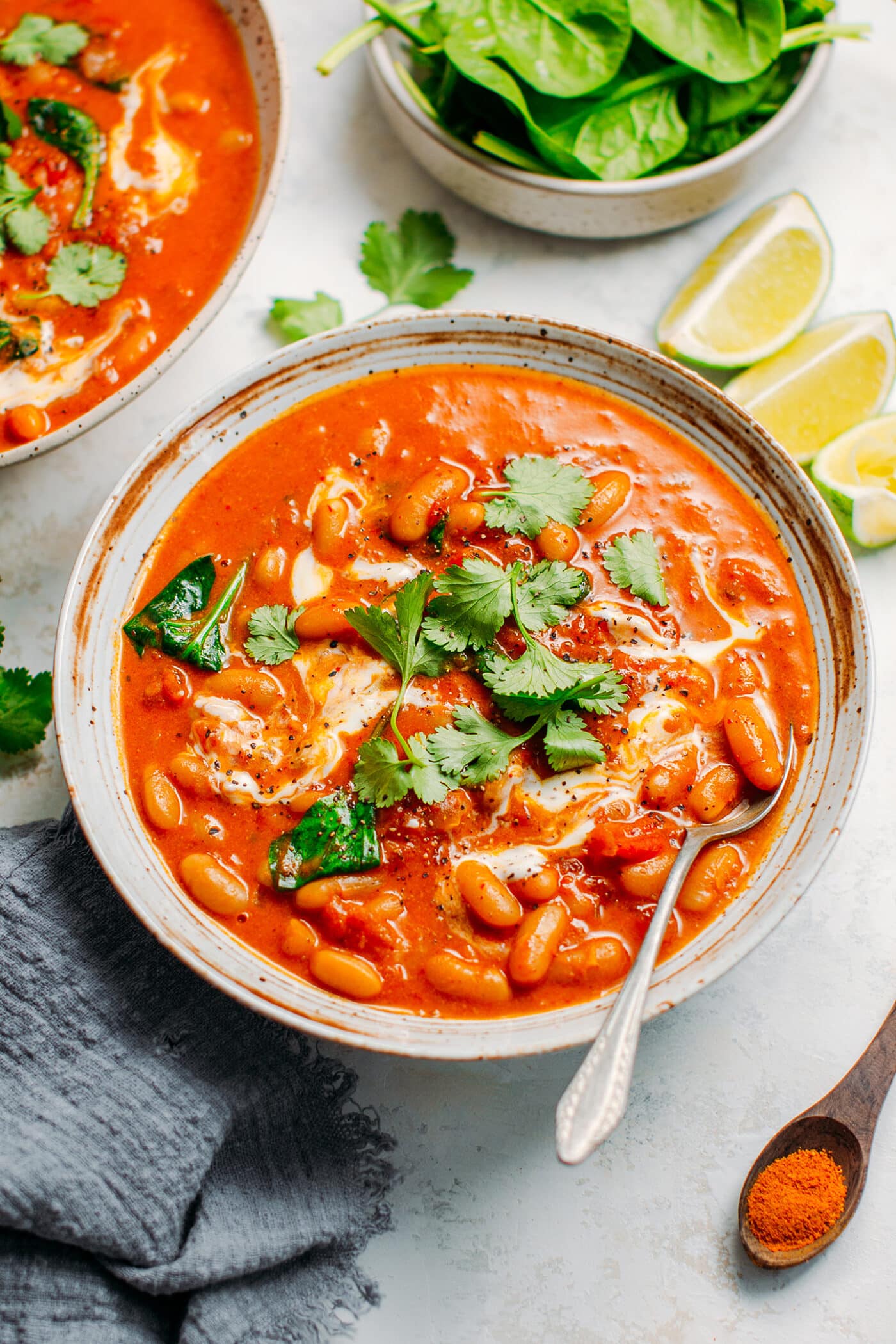 White bean curry topped with cilantro and coconut cream.