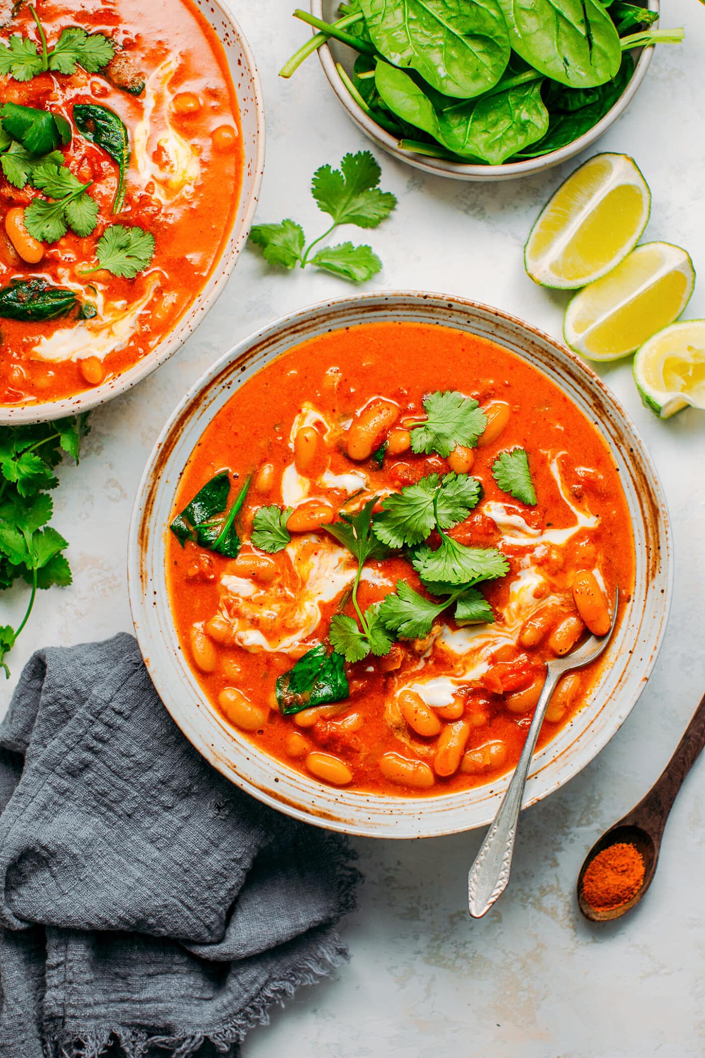 Red curry topped with cilantro and coconut cream.