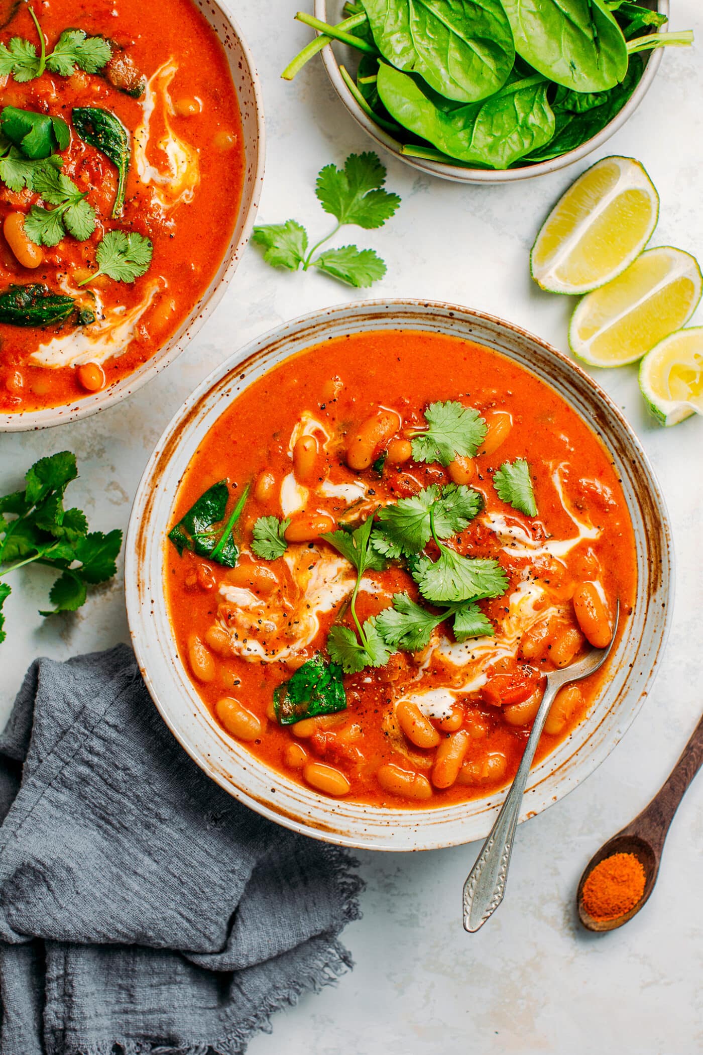 White bean curry topped with cilantro and coconut cream.