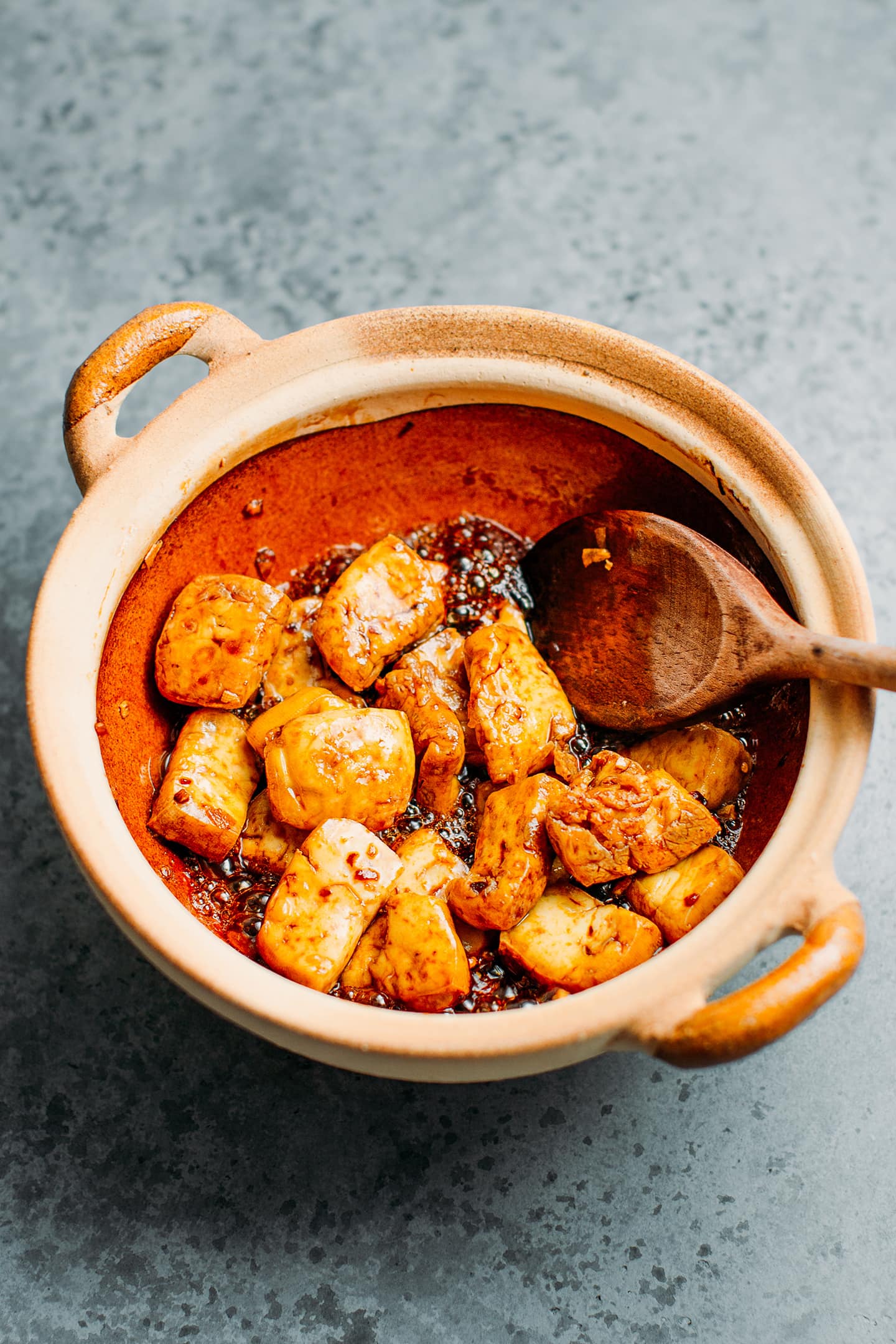 Fried tofu with soy sauce in a clay pot.