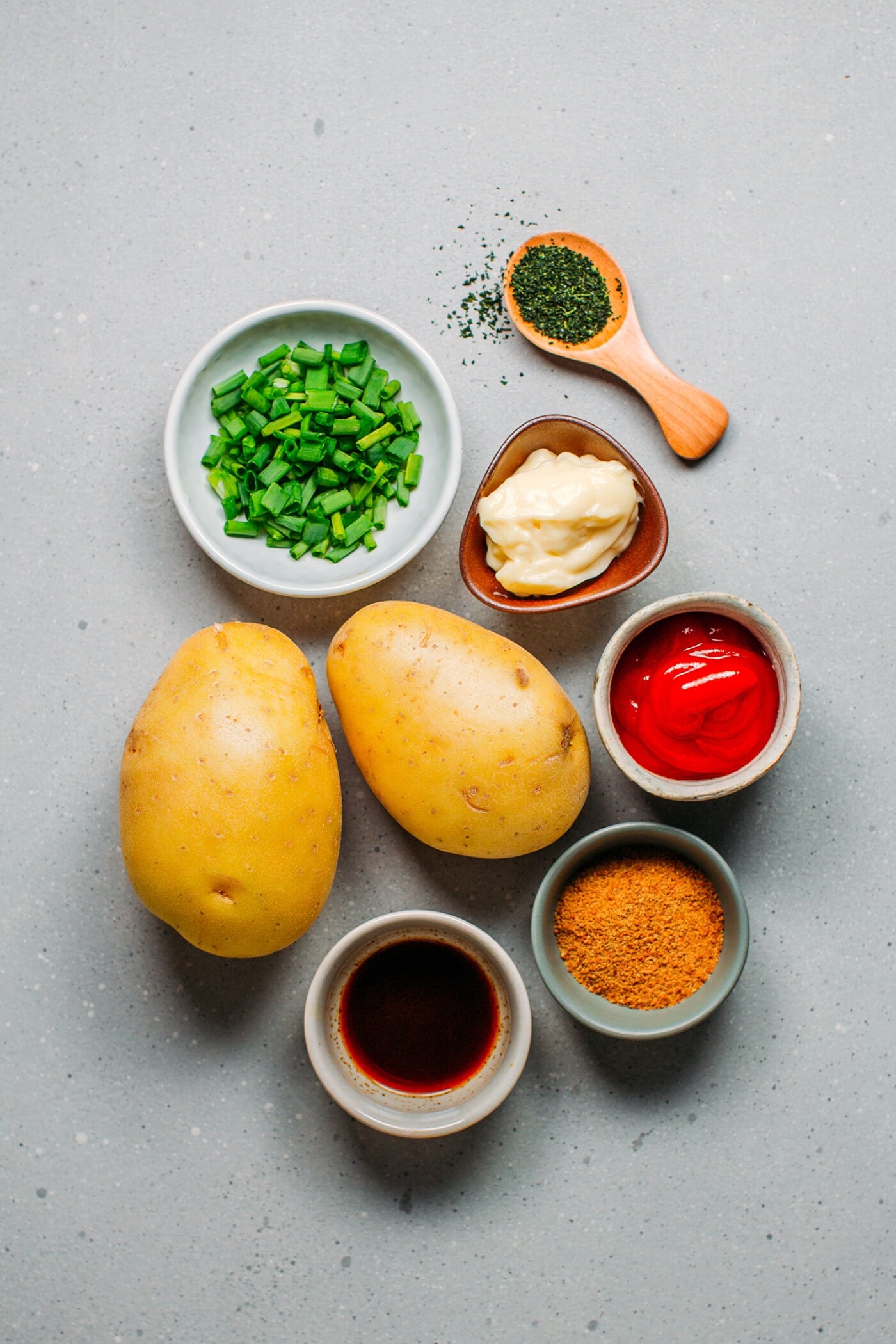 Ingredients like potatoes, green onions, ketchup, worcestershire sauce, coconut sugar, mayo.