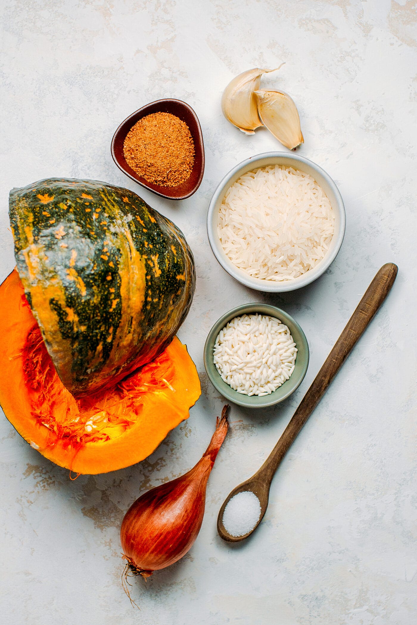 Ingredients like kabocha squash, rice, coconut sugar, garlic, and shallot.