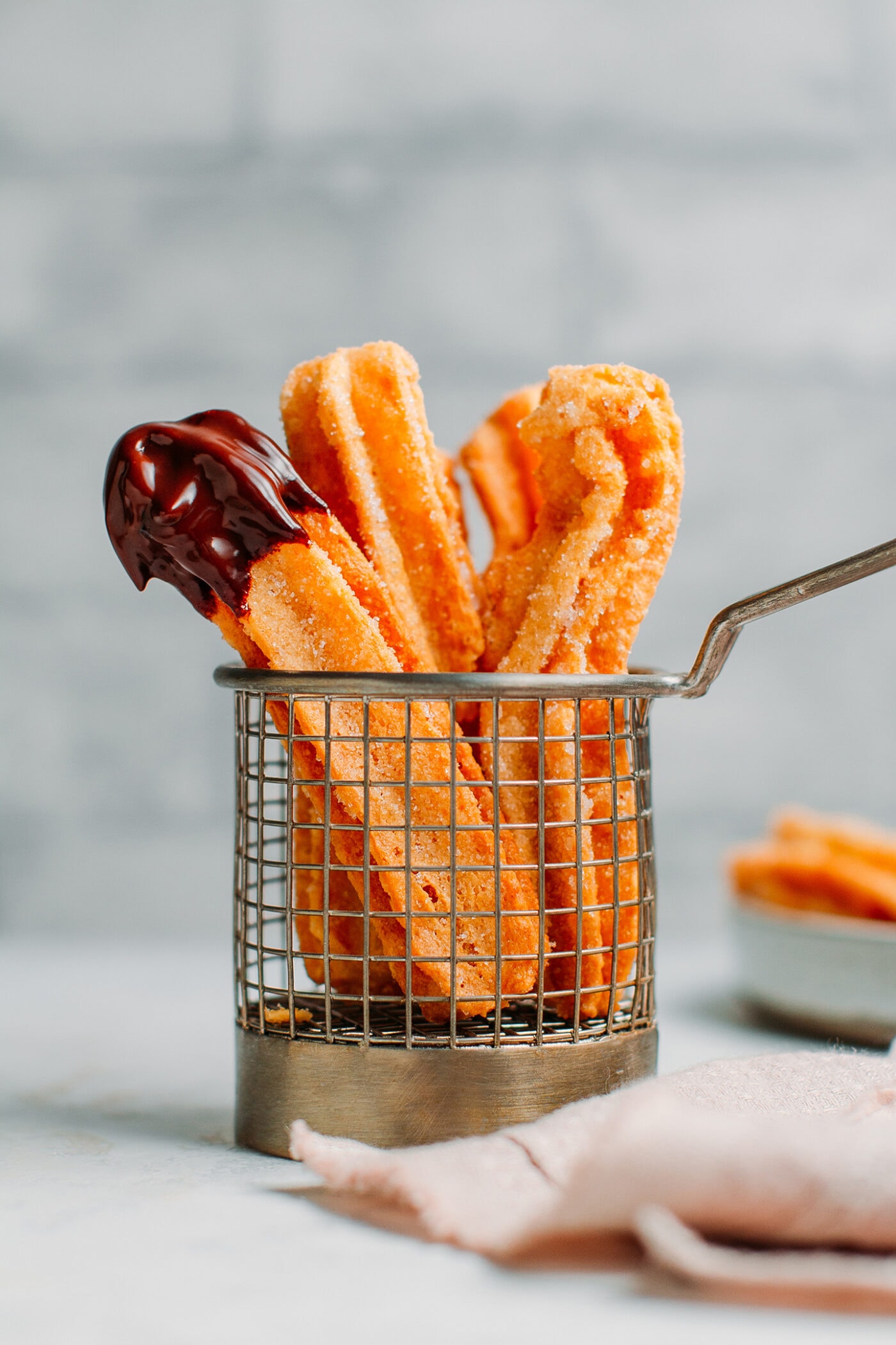 Vegan churros dipped in dark chocolate sauce.