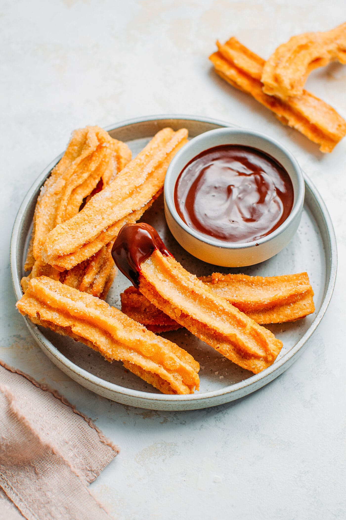 Vegan gluten-free churros with a chocolate dipping sauce.
