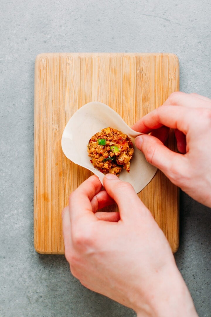 Wrapping kimchi dumpling.