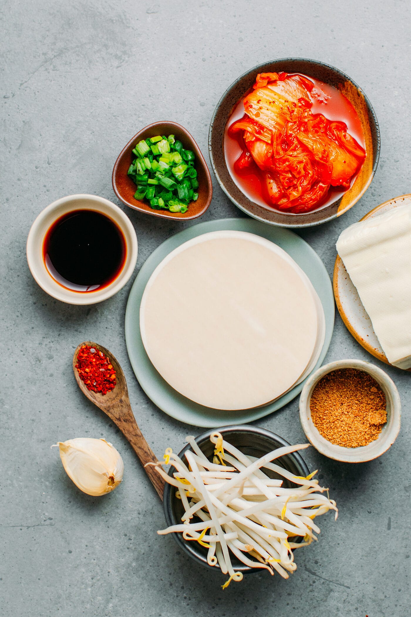 Ingredients like kimchi, bean sprouts, tofu, garlic, green onions.
