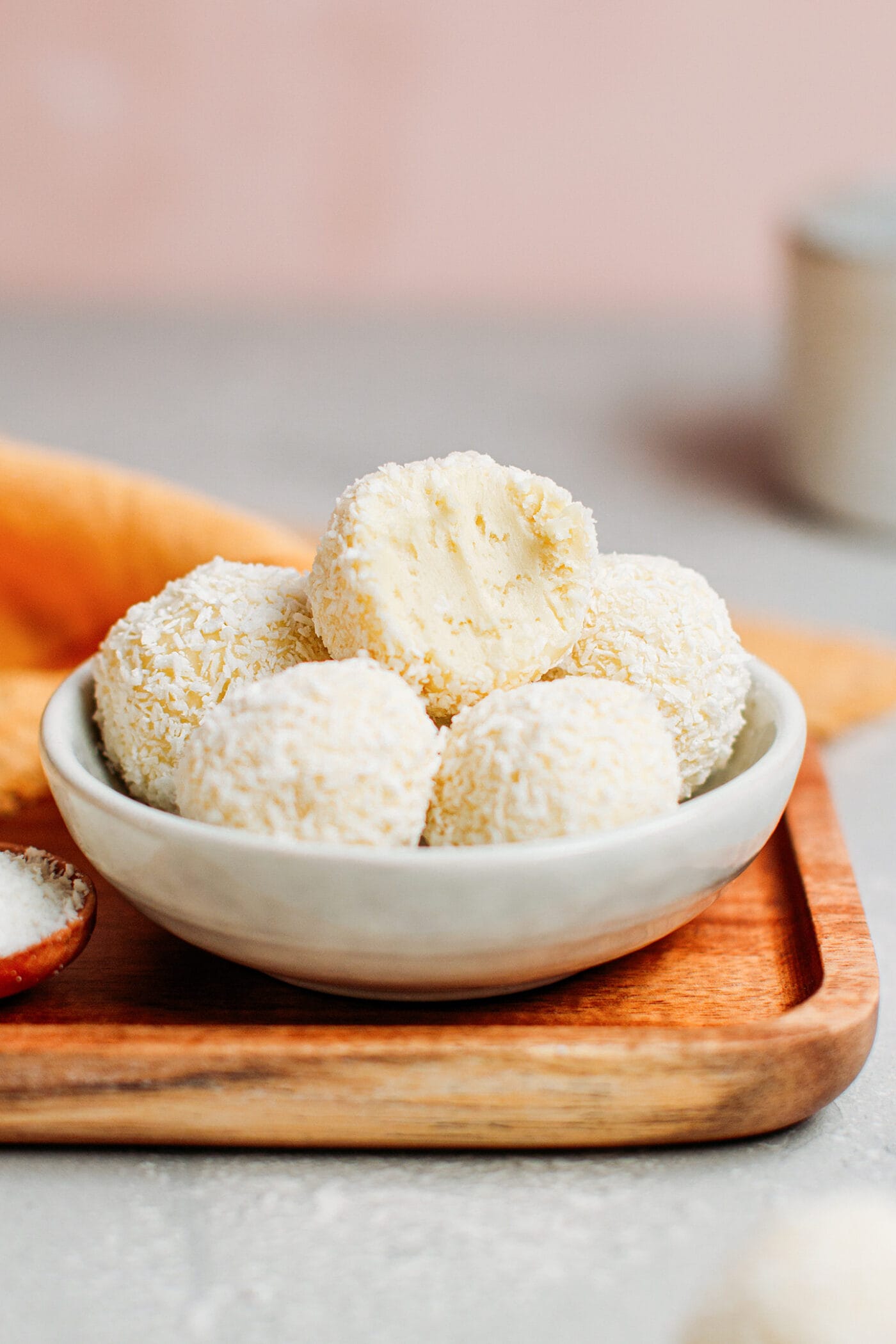 Dairy-free white chocolate truffles coated with shredded coconut.