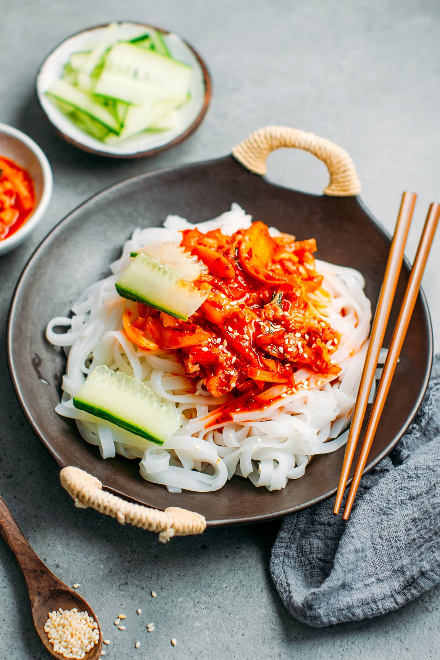 Noodles topped with kimchi sauce and cucumber.