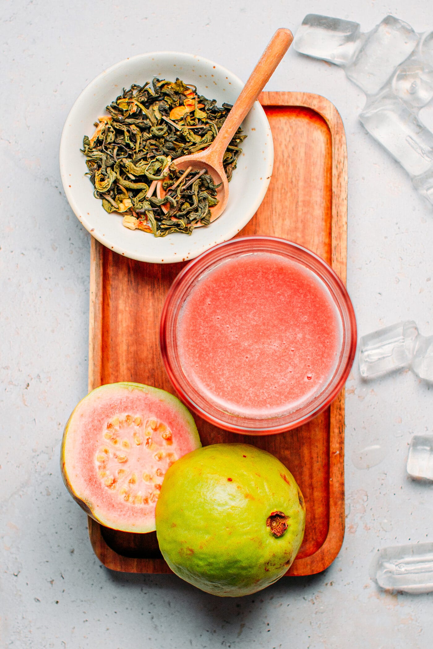 Ingredients like guava juice, loose jasmine tea, and guava fruits.