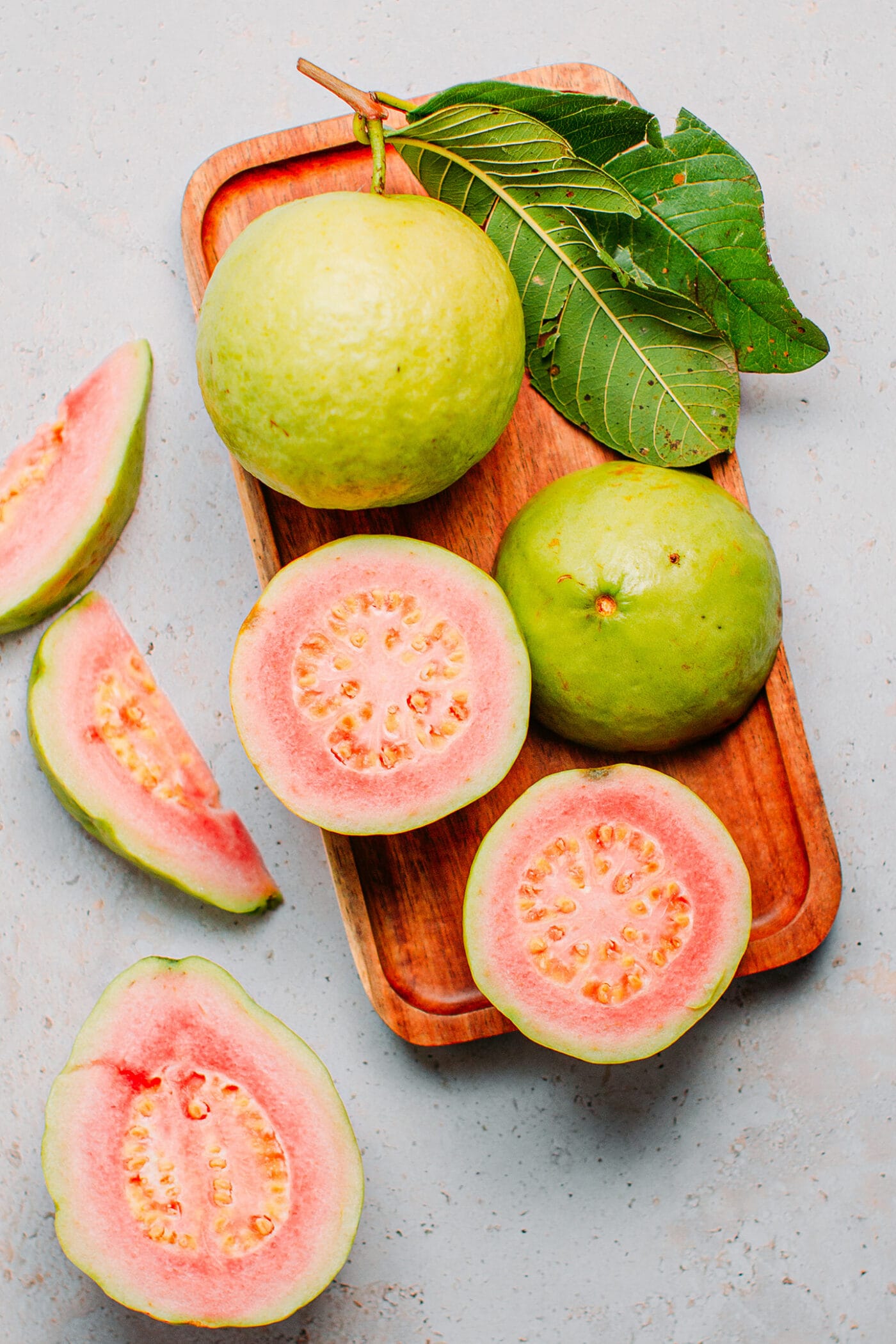 Fresh guava fruits on a wooden board.