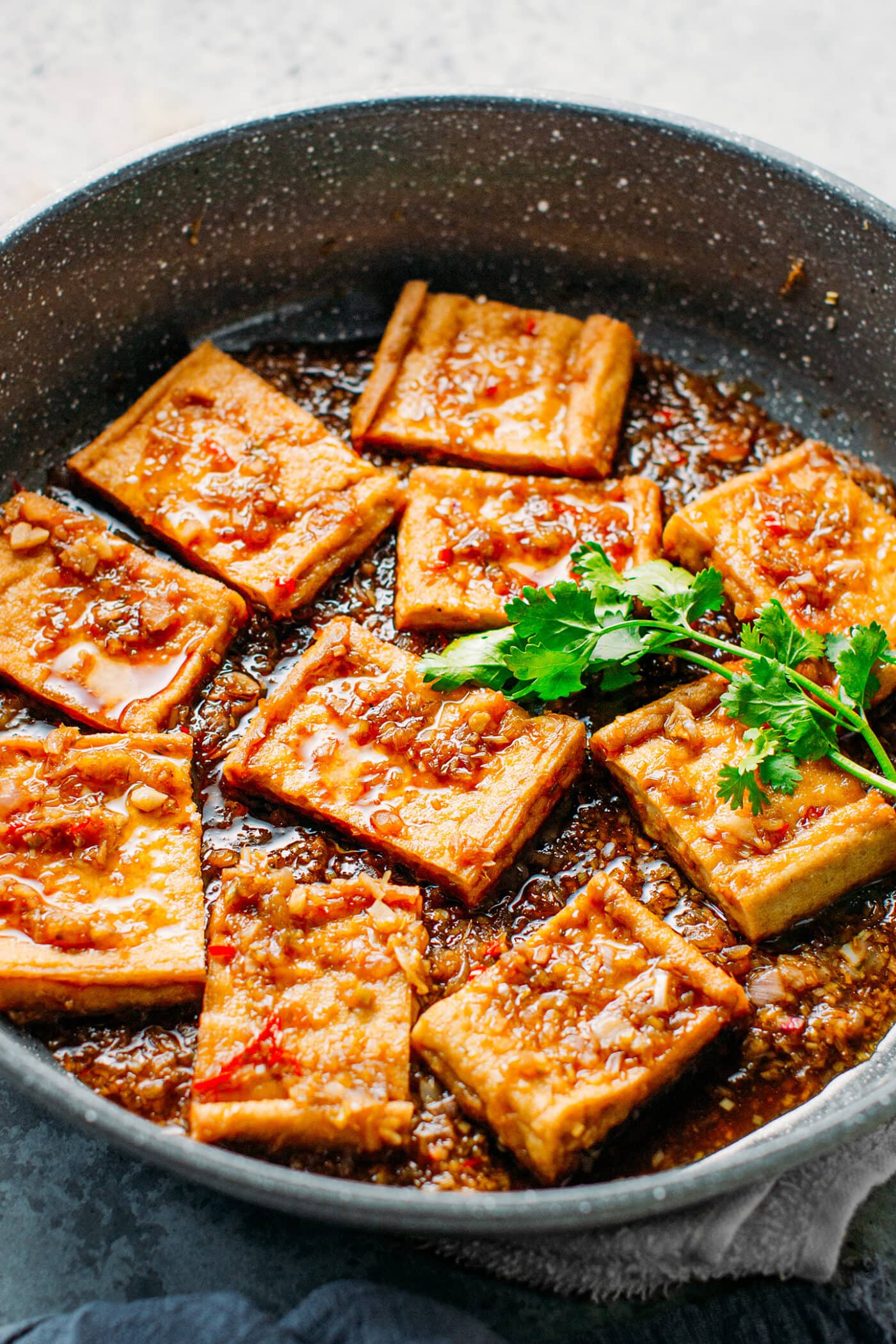 Fried tofu simmering in a lemongrass and chili sauce.
