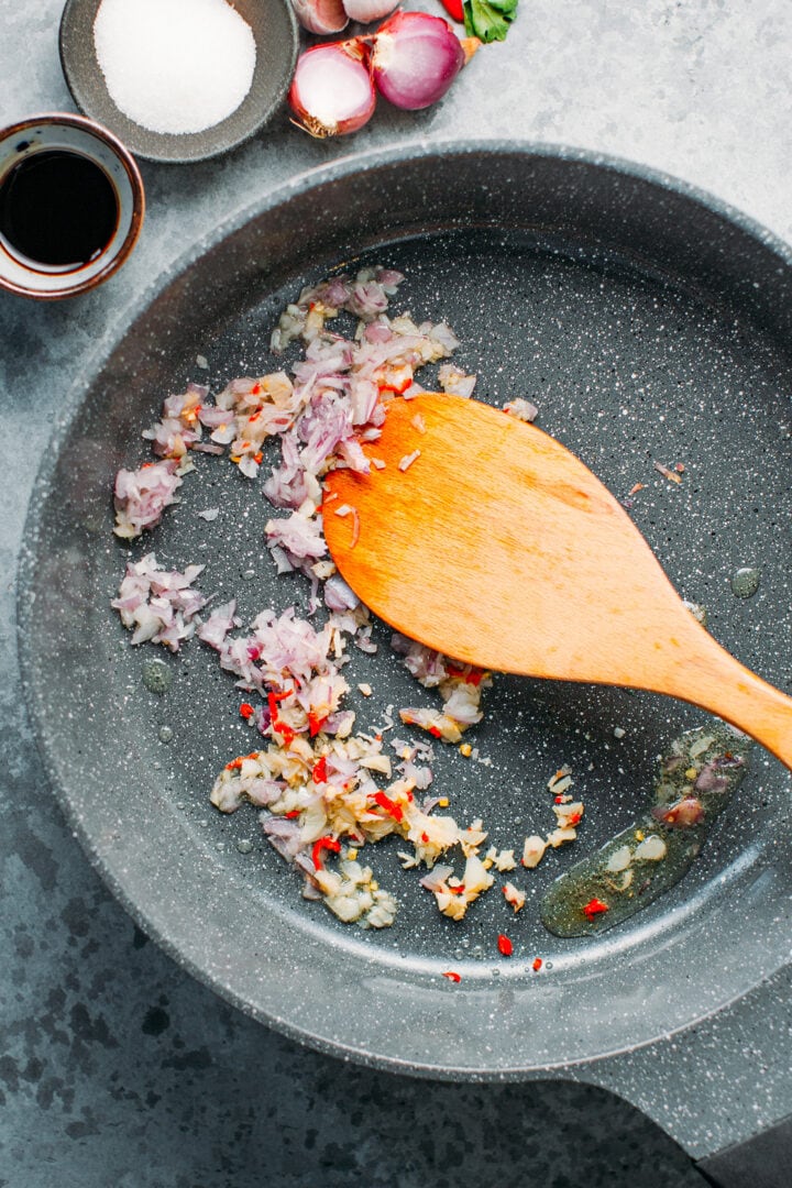 Sautéed lemongrass, garlic, shallots, and chili in a skillet.