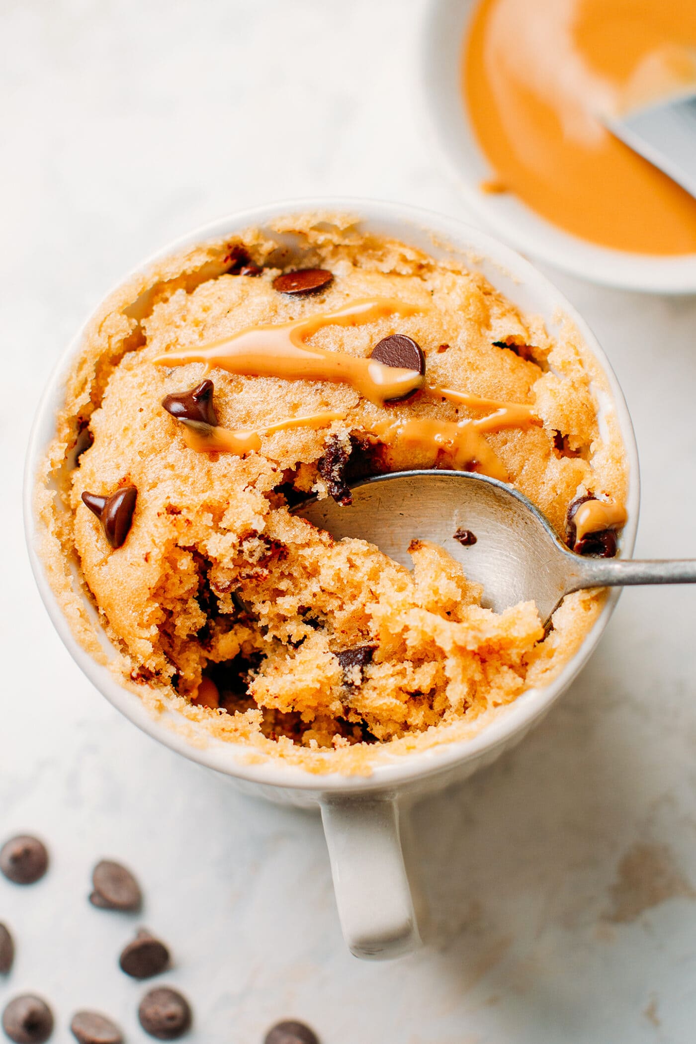 Digging a spoon in peanut butter mug cake.