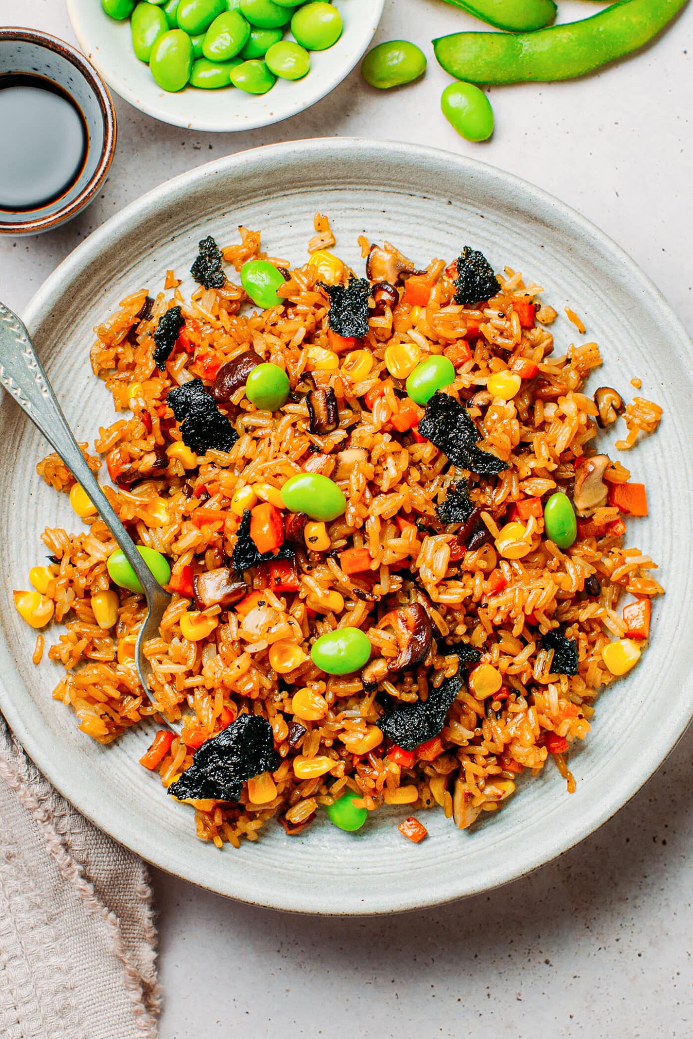 Vegan fried rice with corn, mushrooms, edamame, and nori seaweed.