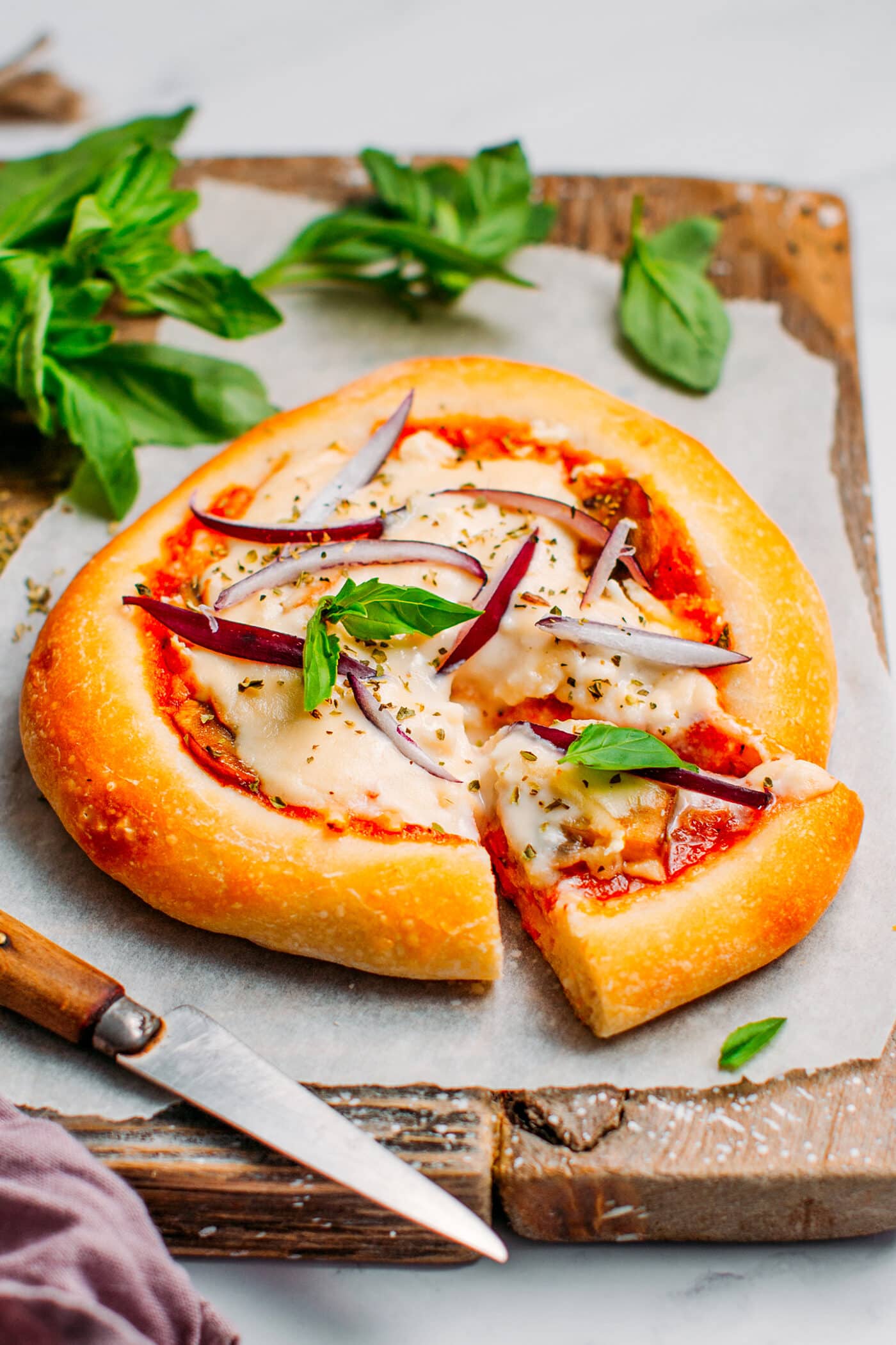 Mini vegan pizza with mushrooms, cheese, onions, and basil.