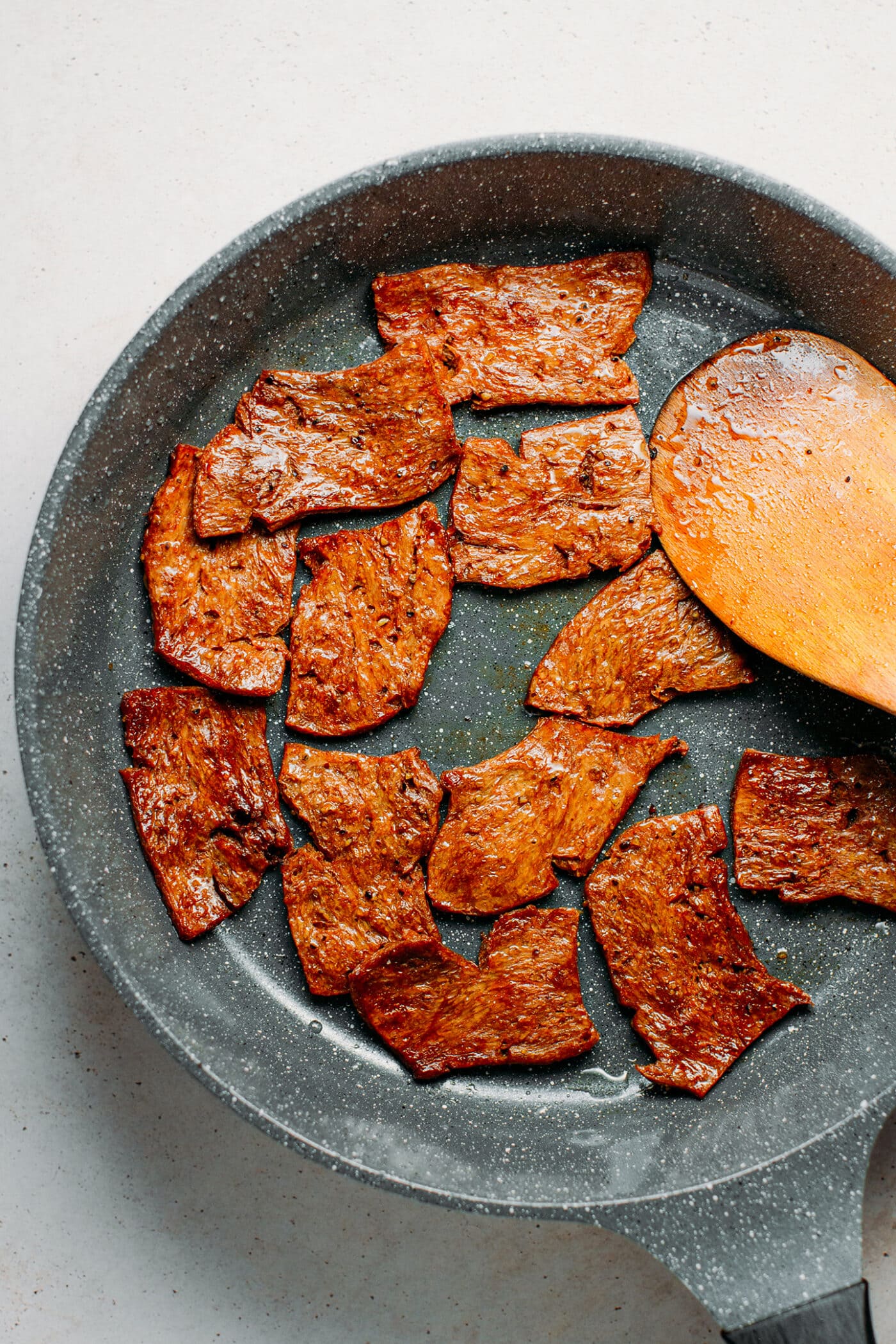 Sautéed vegan beef in a skillet.