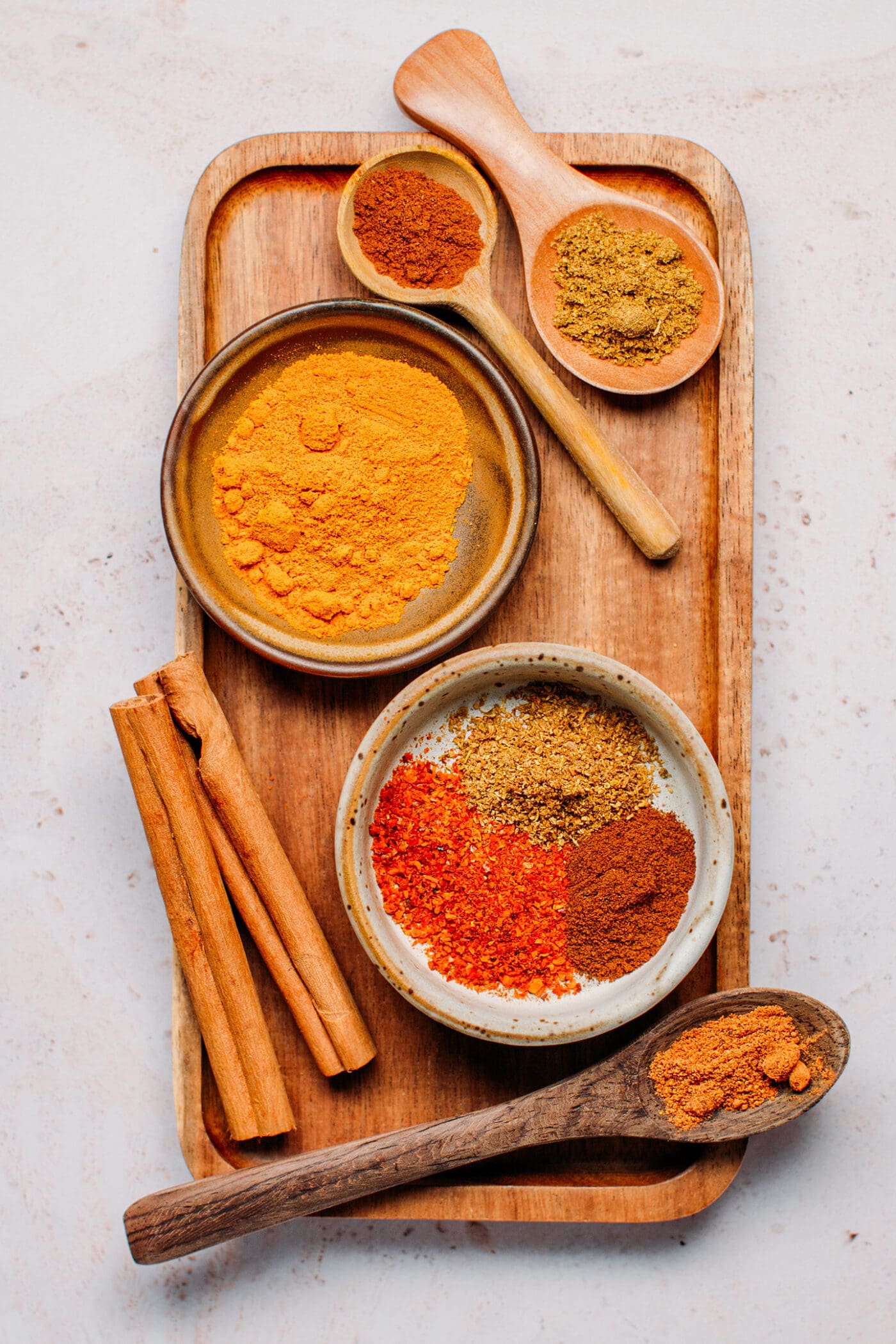 Ingredients like turmeric, annatto powder, five-spice, anise, and cinnamon.