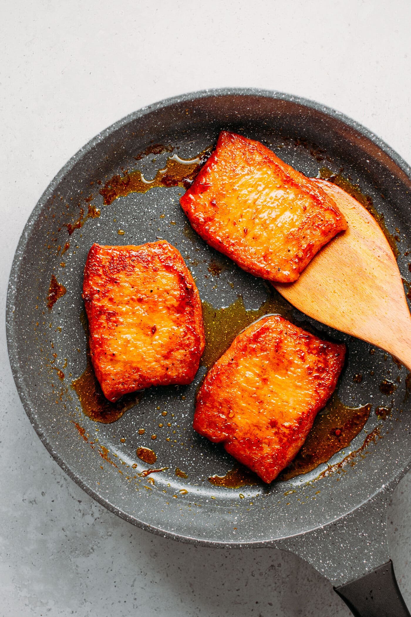 Vegan ribs cooked in a char siu sauce, in a skillet.